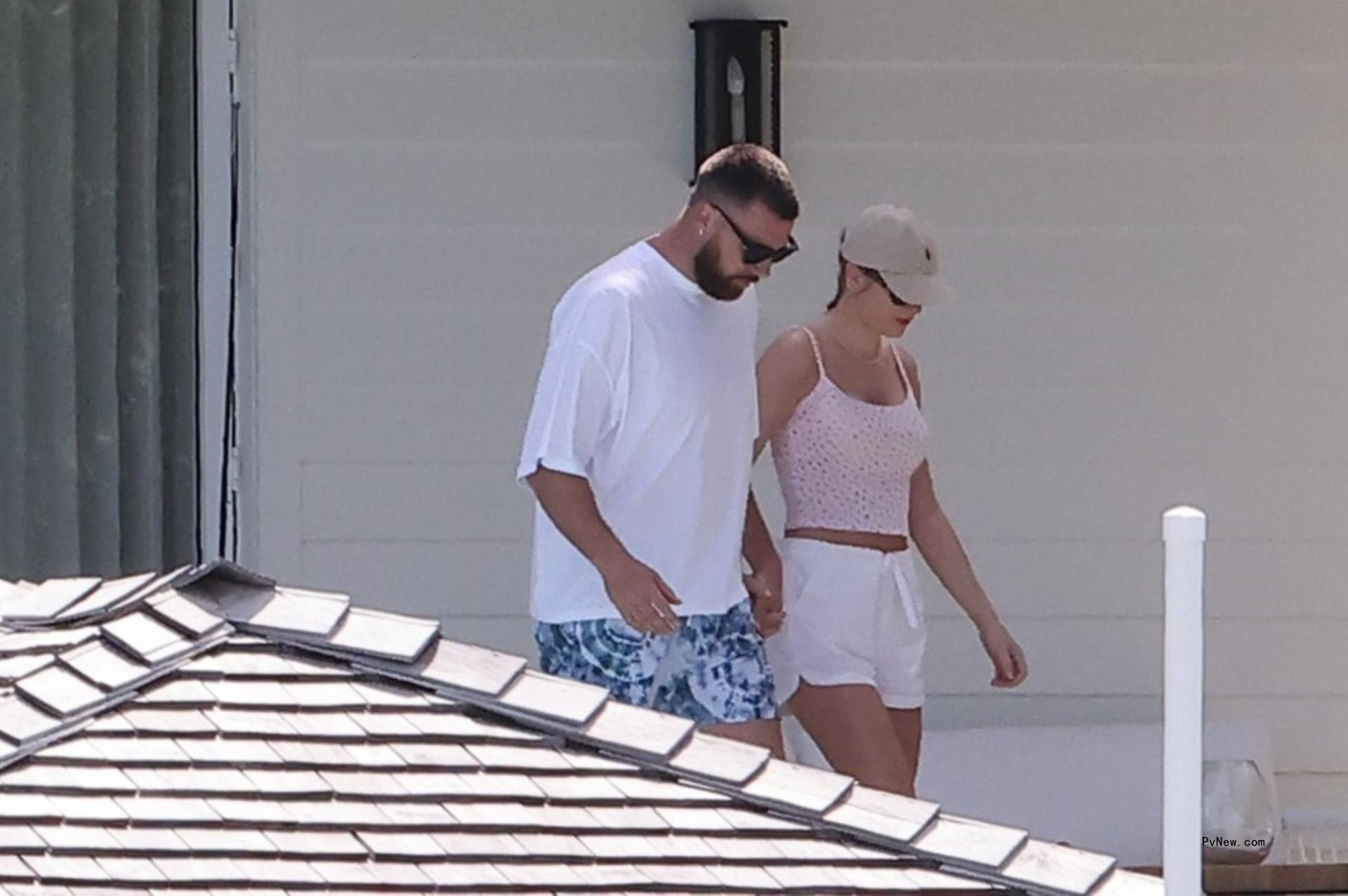 Travis Kelce and Taylor Swift holding hands in the Bahamas.