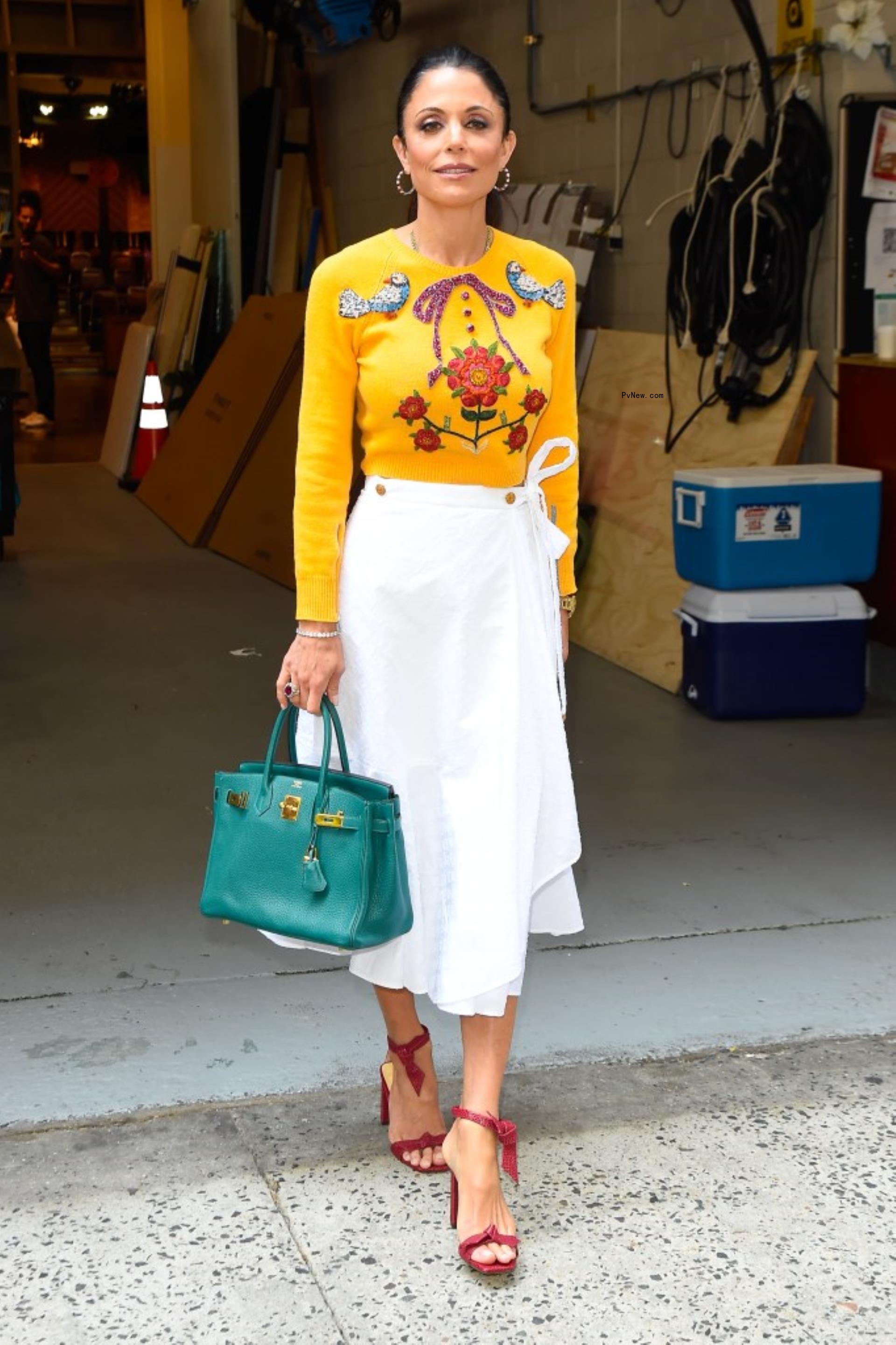Bethenny Frankel in NYC in white maxi skirt and yellow top.