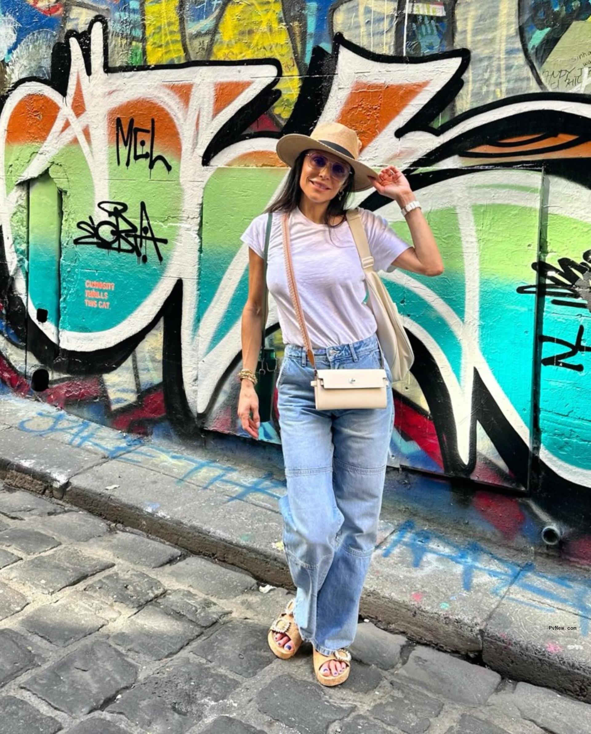 Bethenny Frankel in front of graffiti wall.