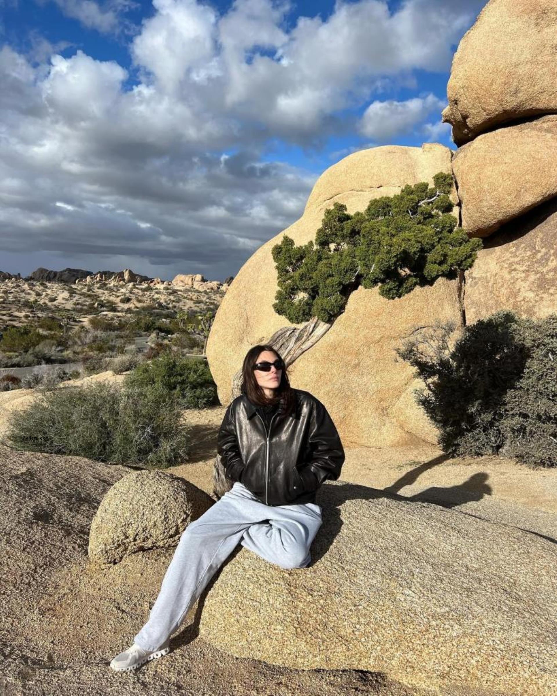 Vittoria Ceretti on a scenic mountain. 