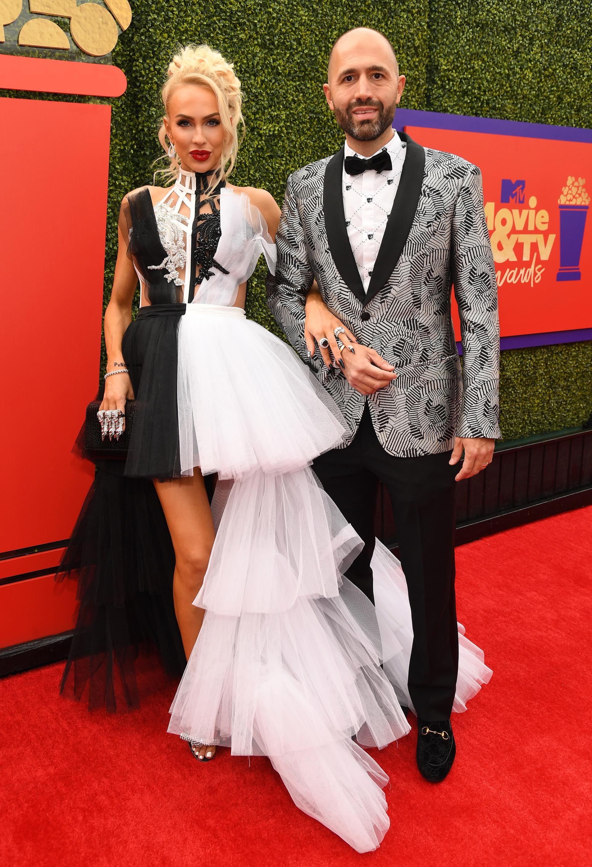 Christine Quinn and Christian Richard posing on a red carpet