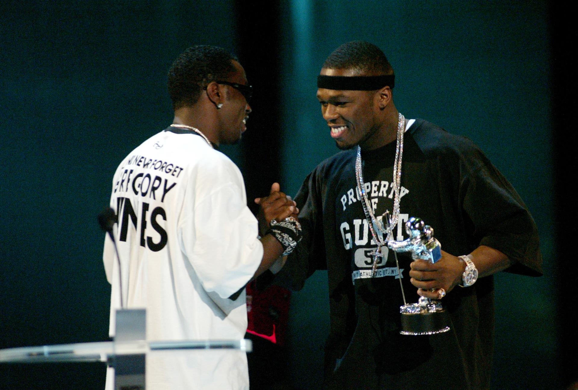 50 Cent and Diddy shaking hands.