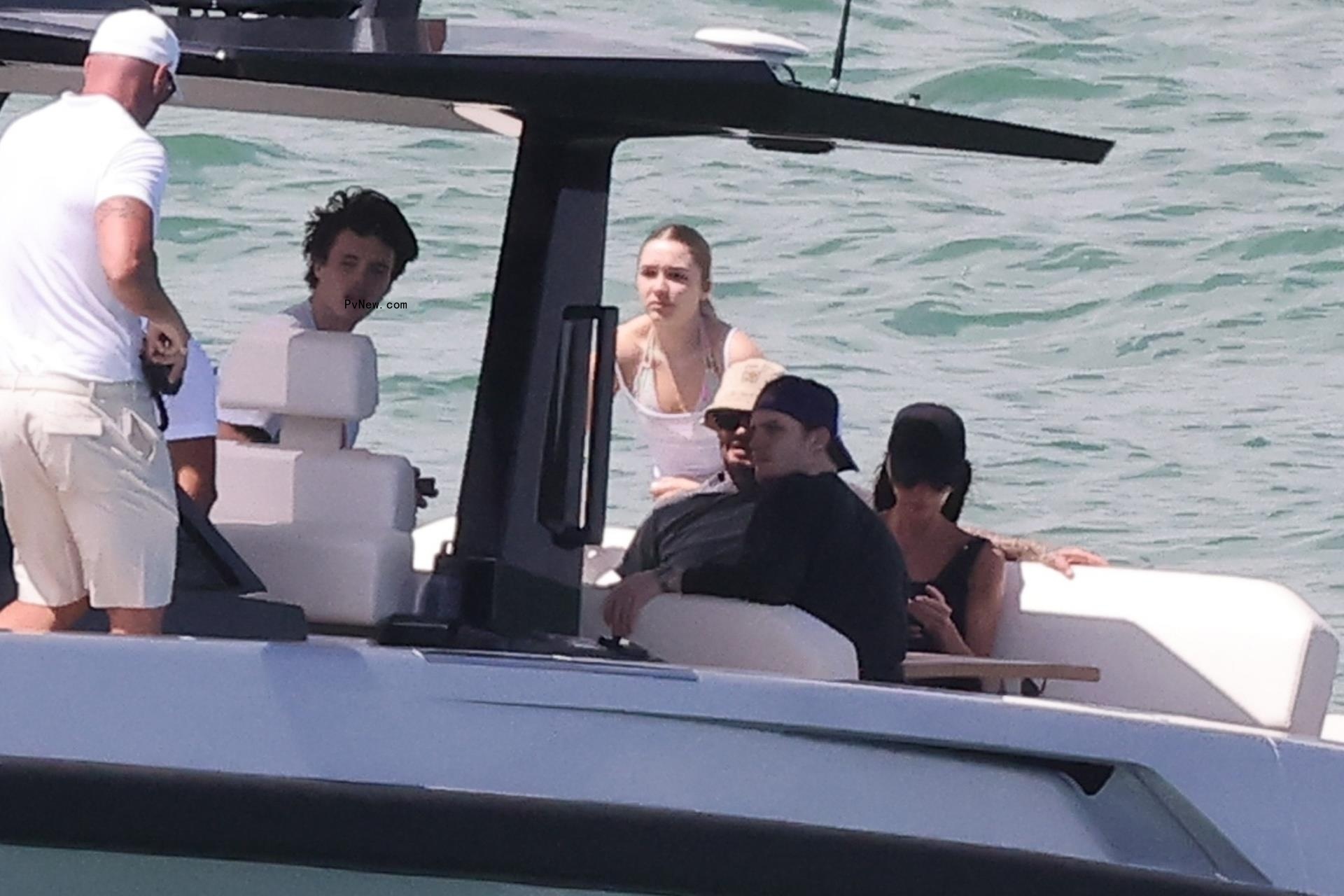 David Beckham and Victoria Beckham on a boat with their kids.