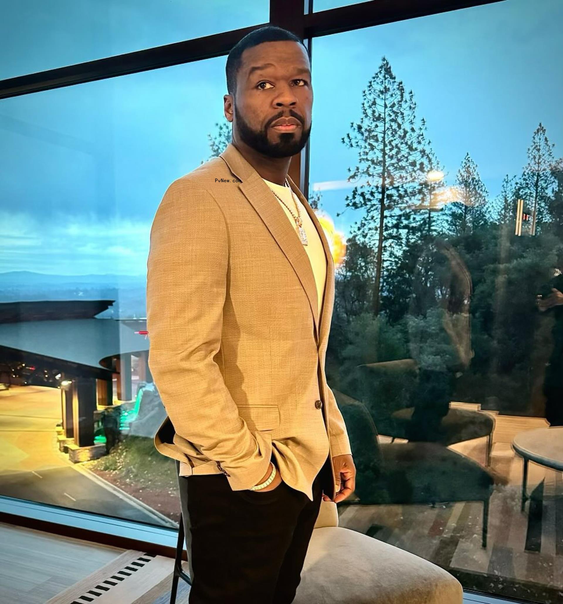50 Cent in a tan blazer.