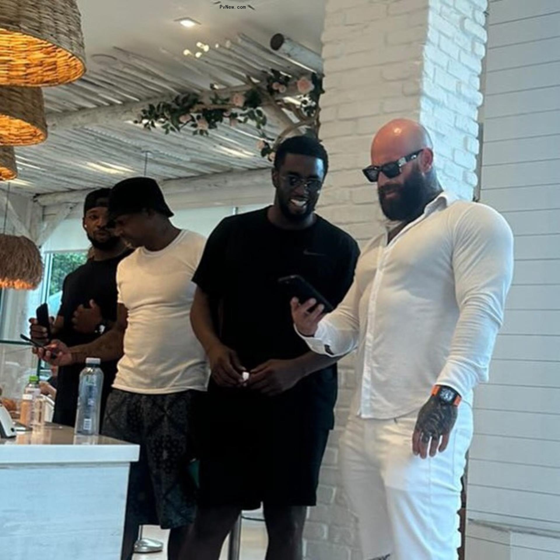Diddy smiling with Wes Watson
