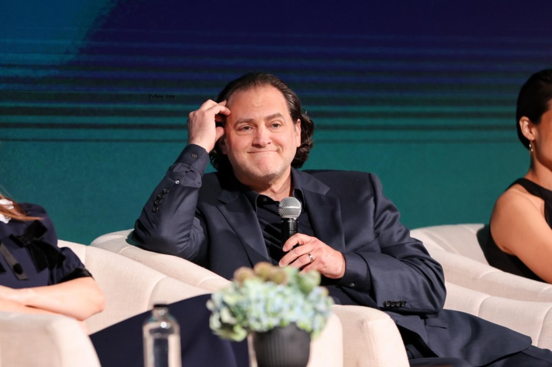 michael stuhlbarg sitting in a chair