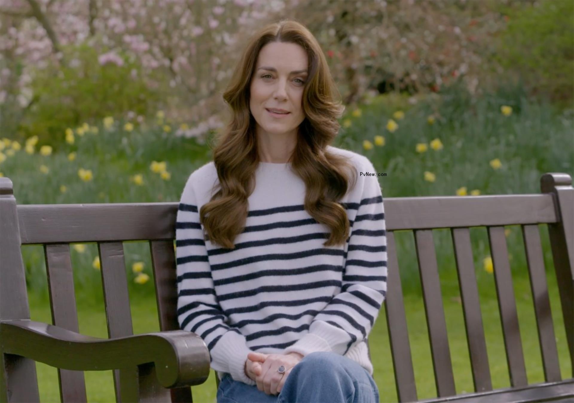 Kate Middleton sitting on a bench.