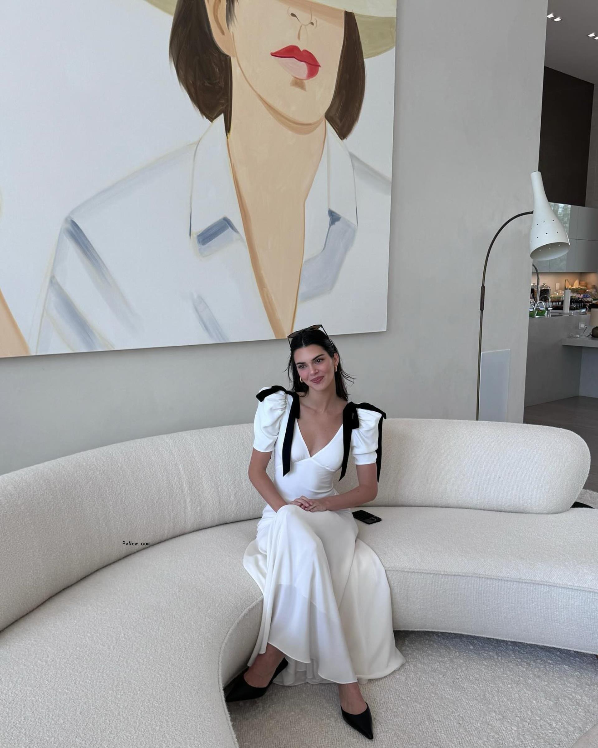 Kendall Jenner sitting on a couch