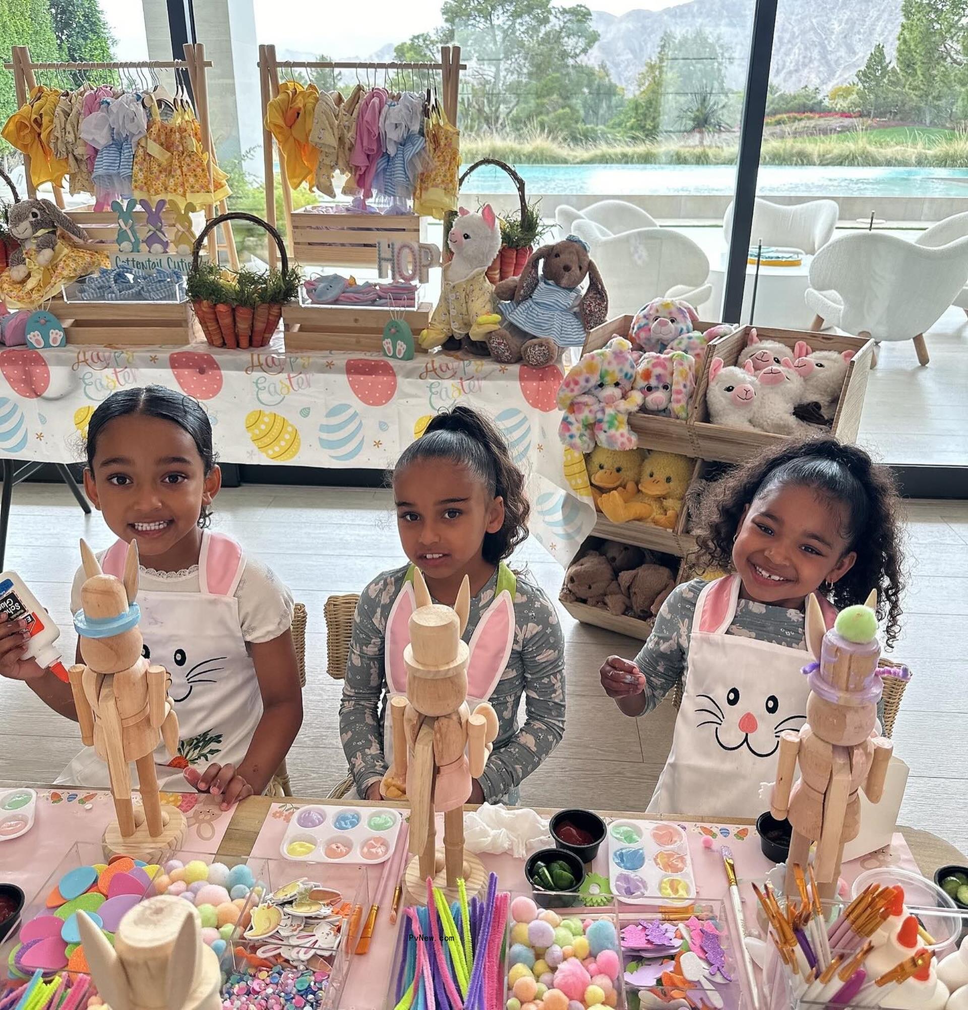 Three of the Kardashian children decorating a wooden toy soldier on Easter