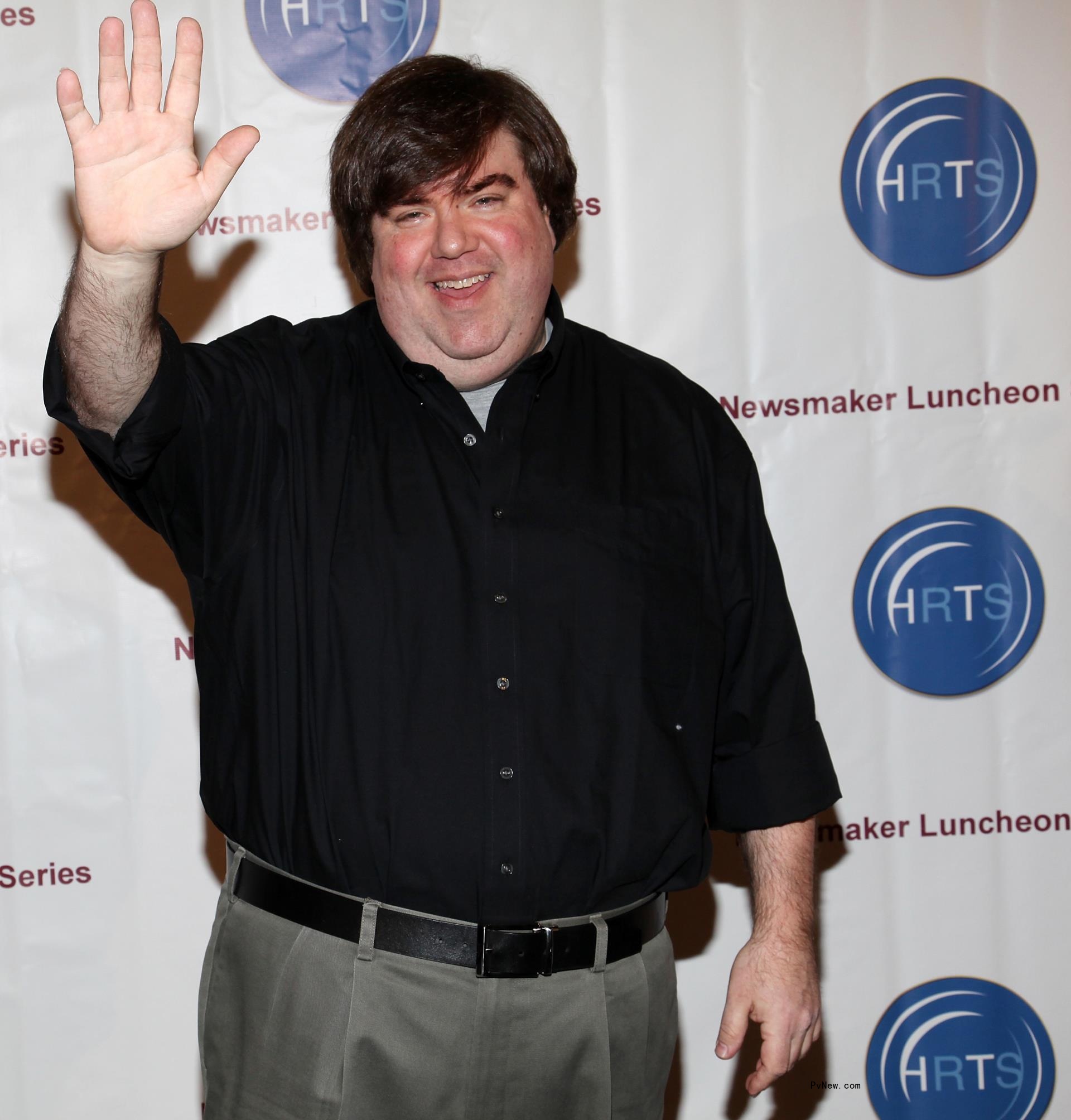 Dan Schneider posing on a carpet
