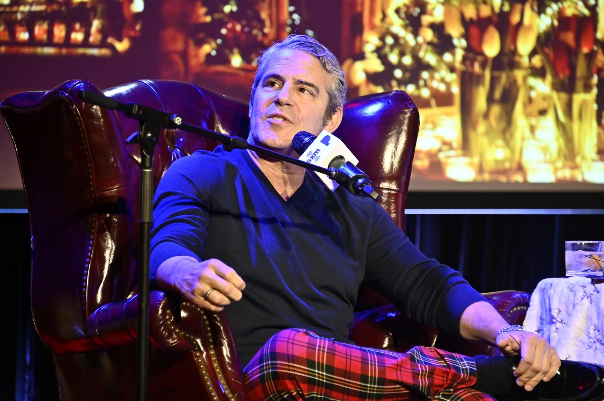 Andy Cohen talking into a mic