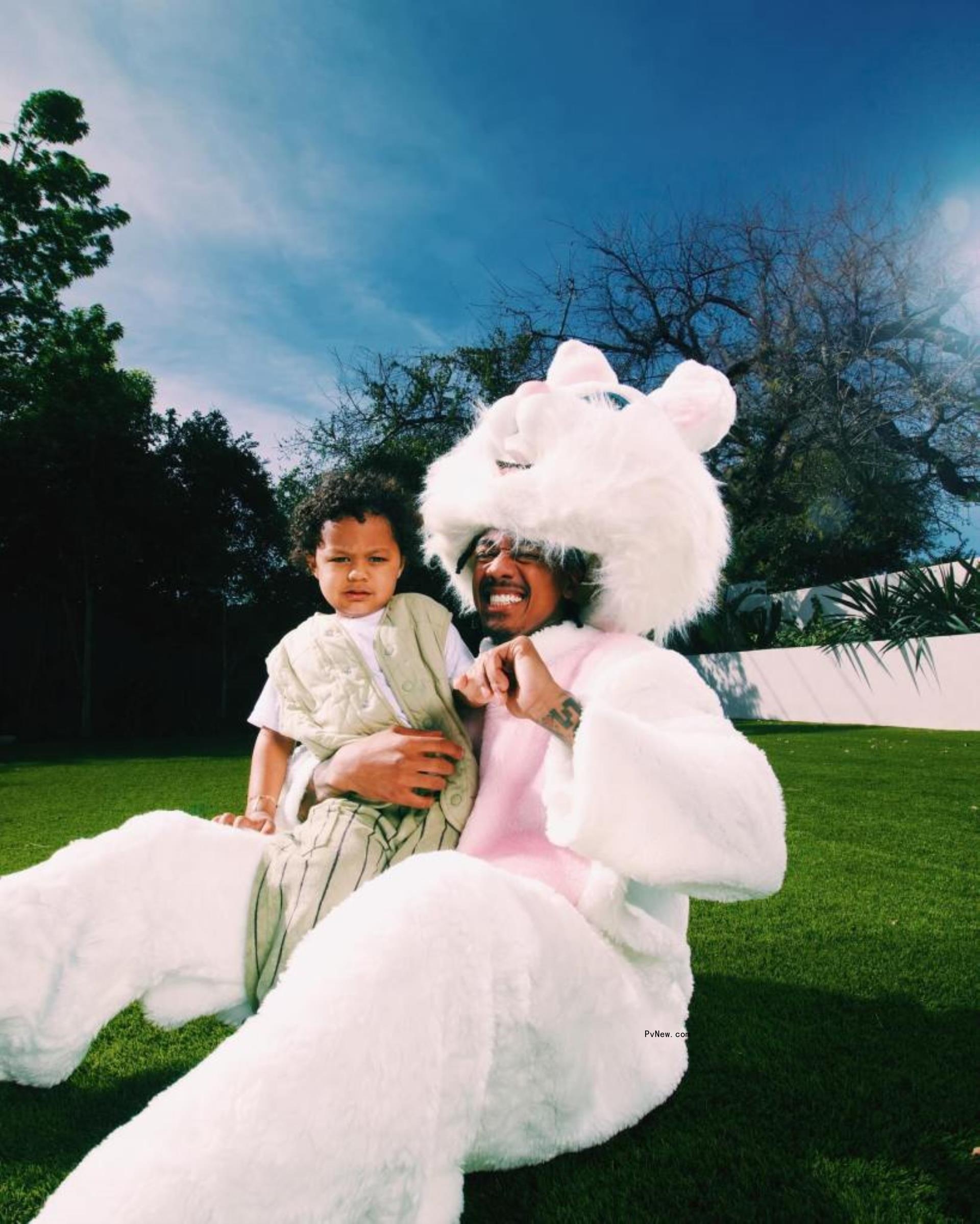 Nick Cannon in an Easter bunny suit with his son