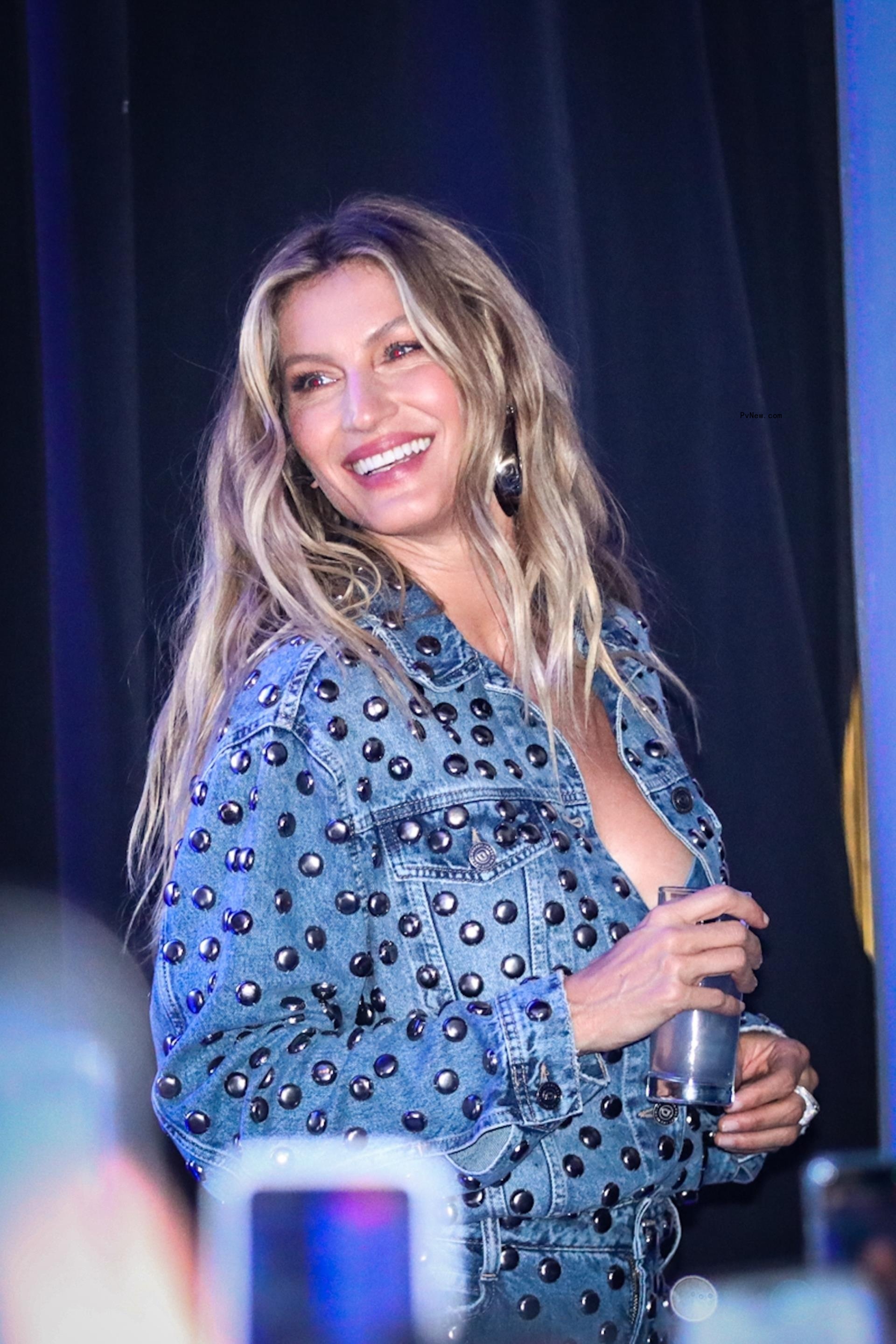 Gisele Bündchen smiling in a denim outfit