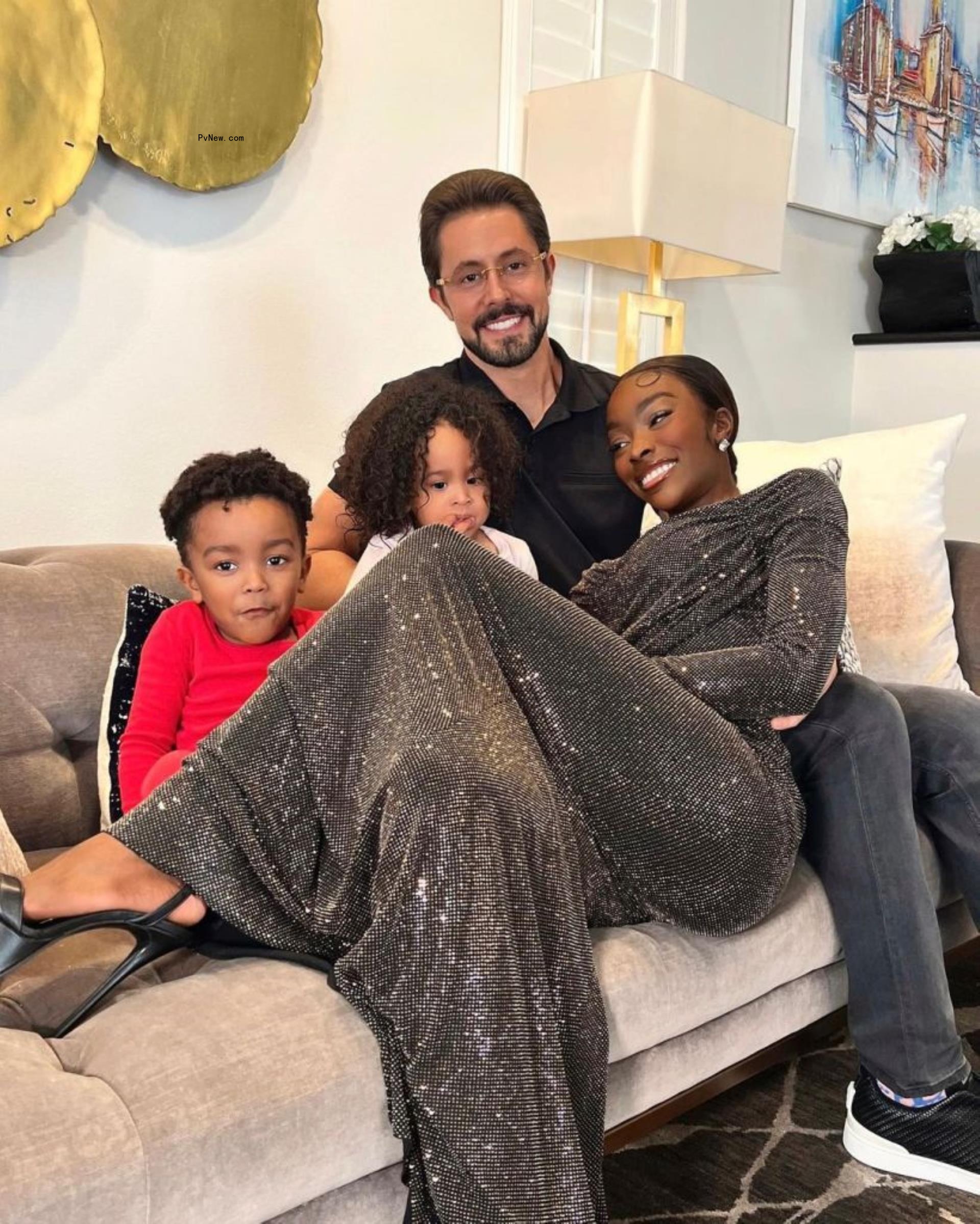 Jeff Lazkani and Chelsea Lazkani on a couch with their kids.