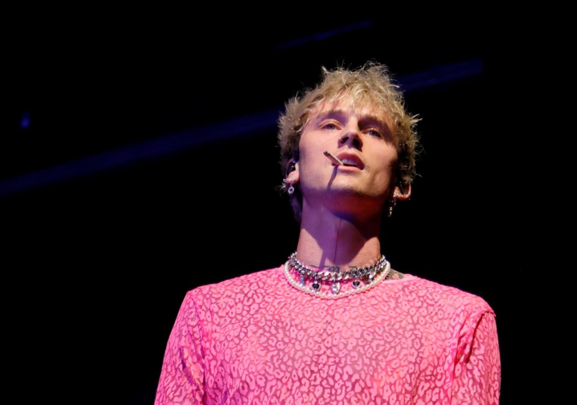 Machine Gun Kelly smoking a cigarette. 