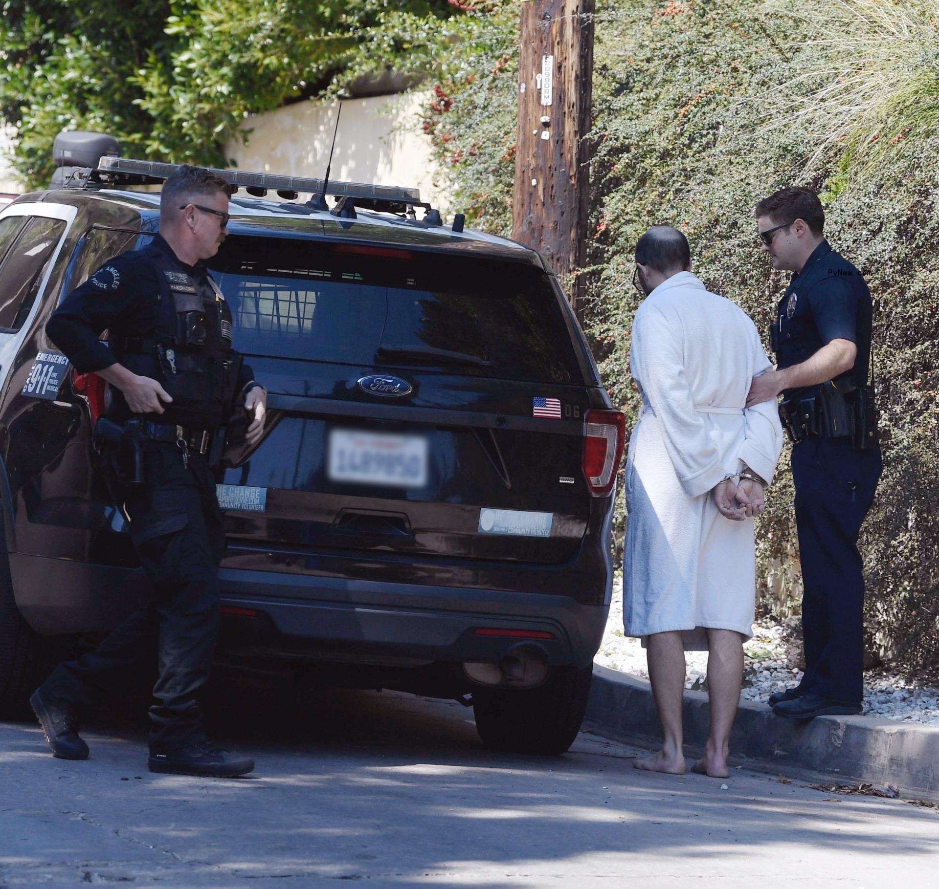 Christian Richard being arrested in a robe.