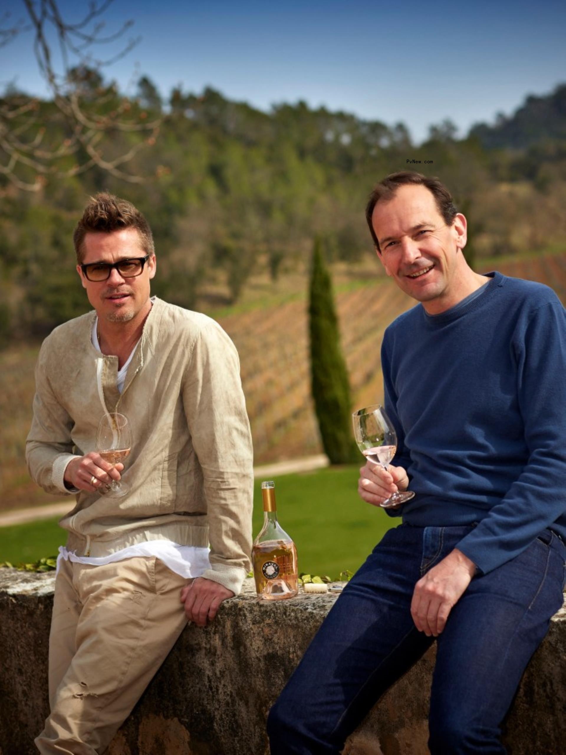 Brad Pitt shares a glass of wine with Marc Perrin.