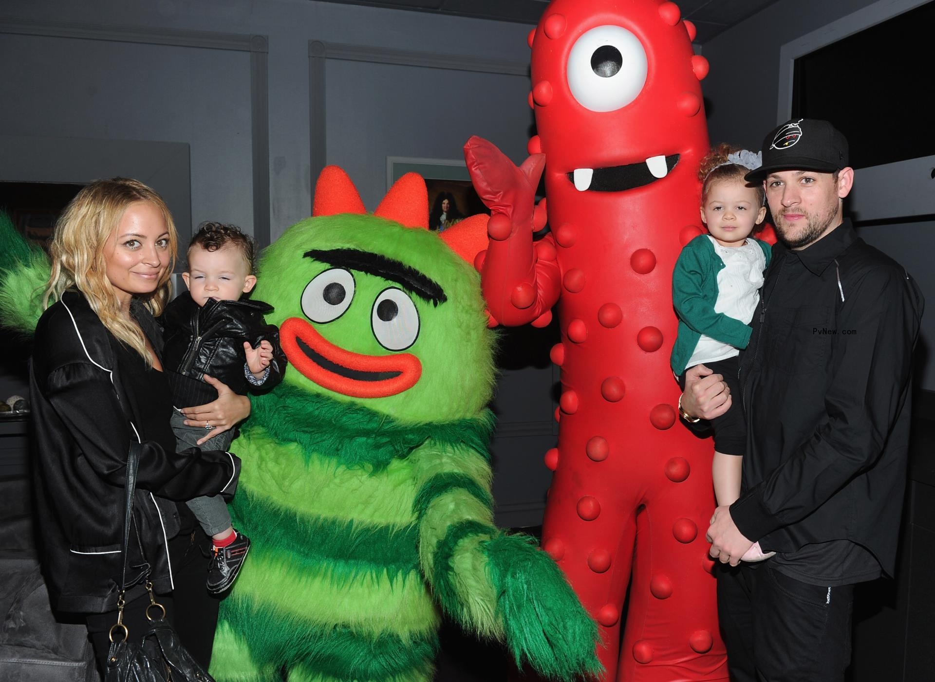 sofia richie, joel madden and their two kids posing with inflatable monsters