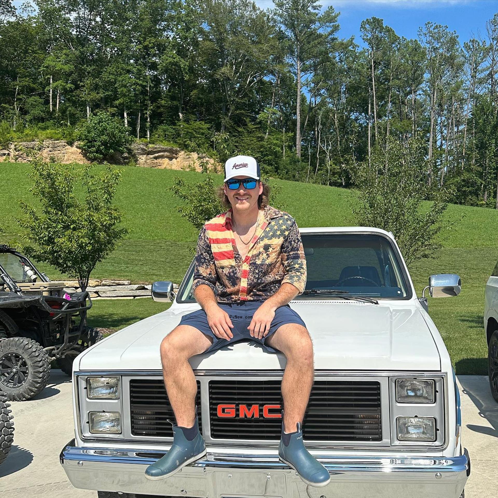 morgan wallen sitting on the hood of a car