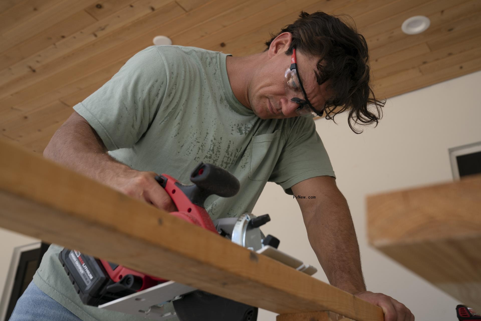 Tyler Cameron sawing a piece of wood