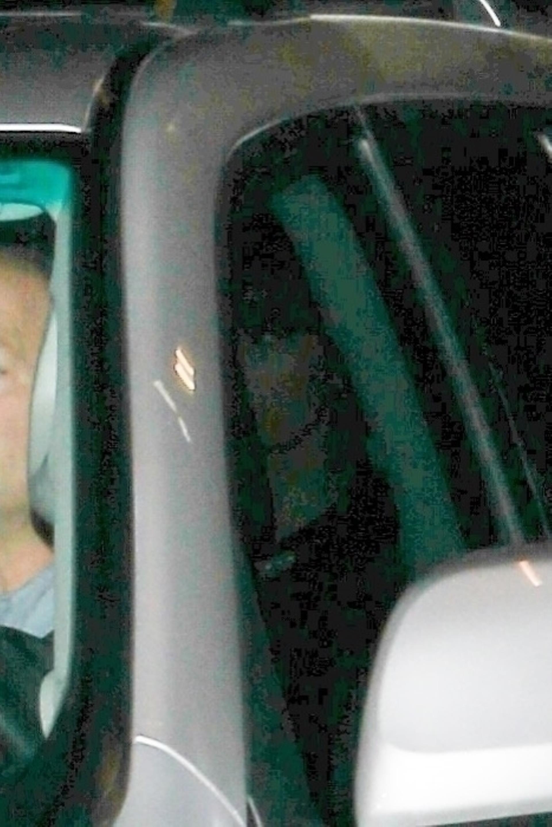 Taylor Swift and Travis Kelce hiding in a car.