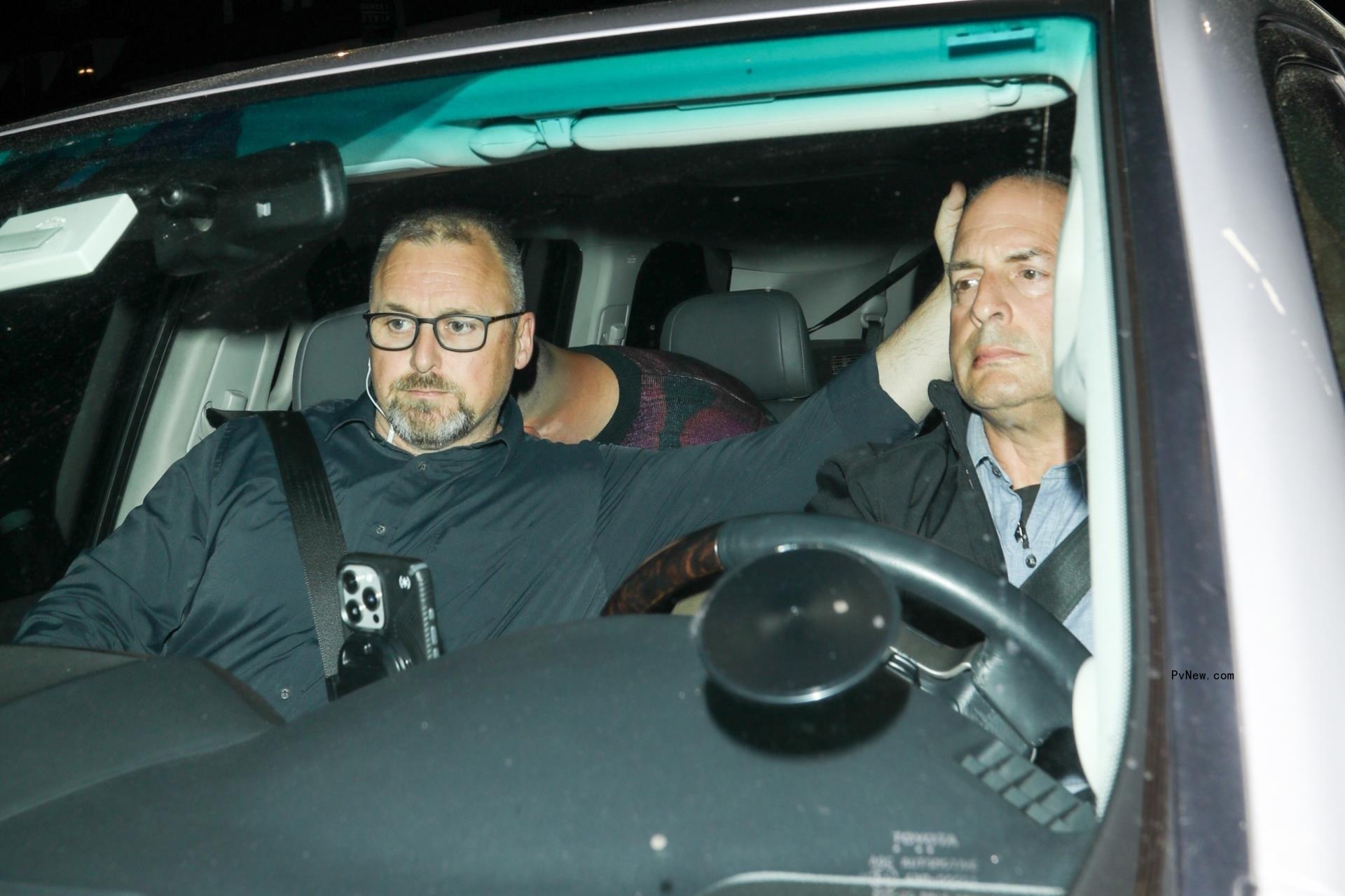 Taylor Swift and Travis Kelce hiding in a car.