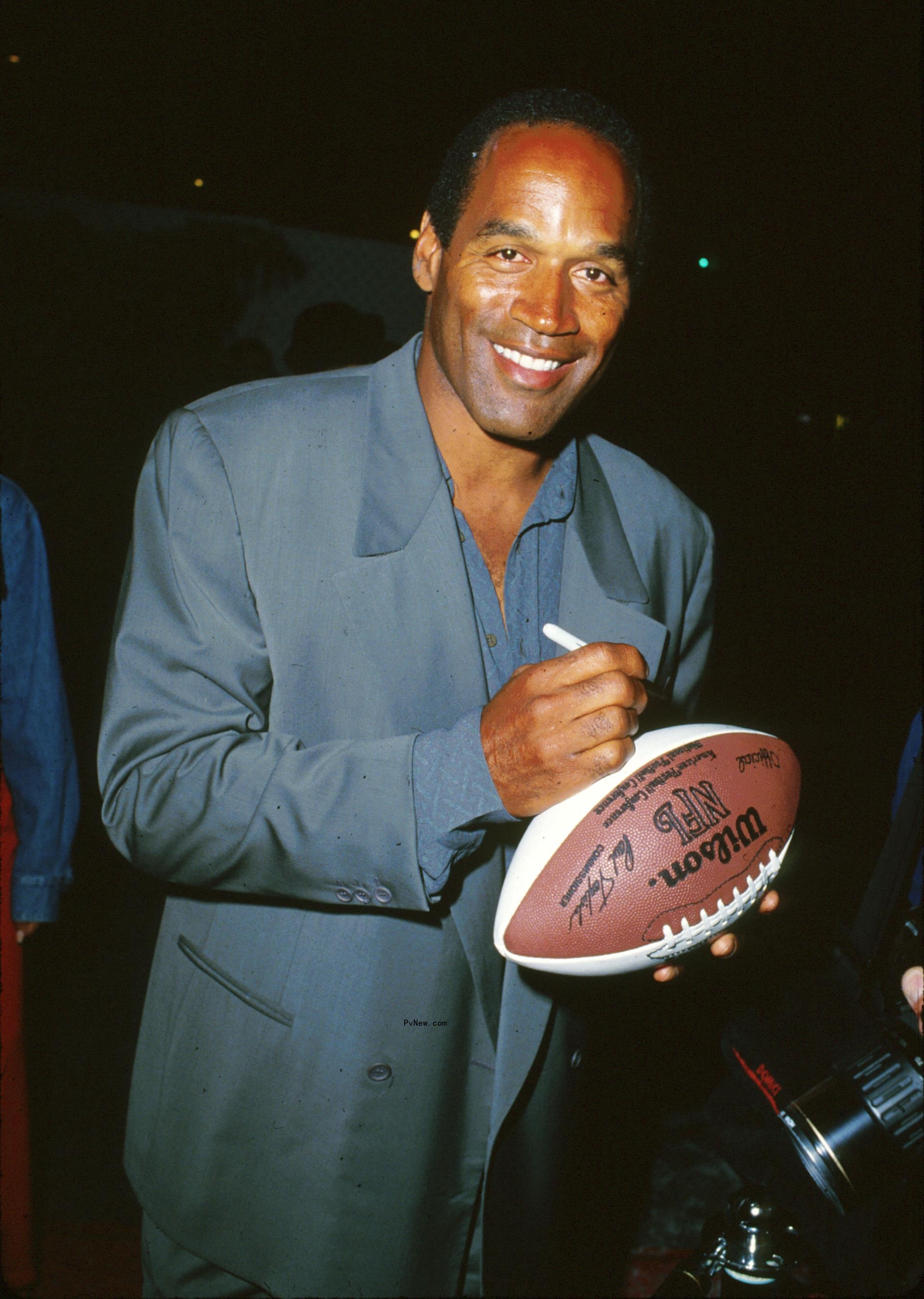 oj simpson signing a football