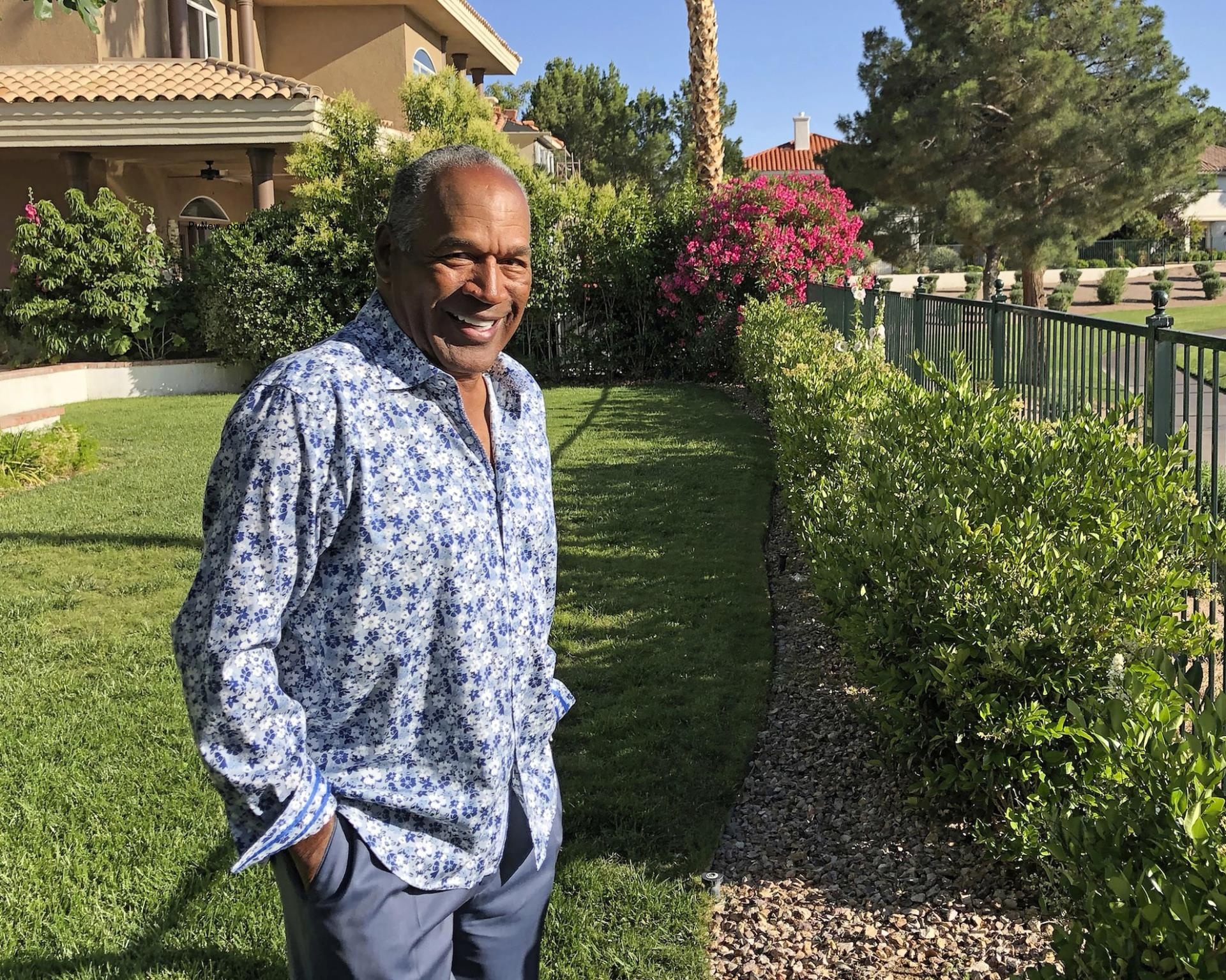 oj simpson standing in a yard