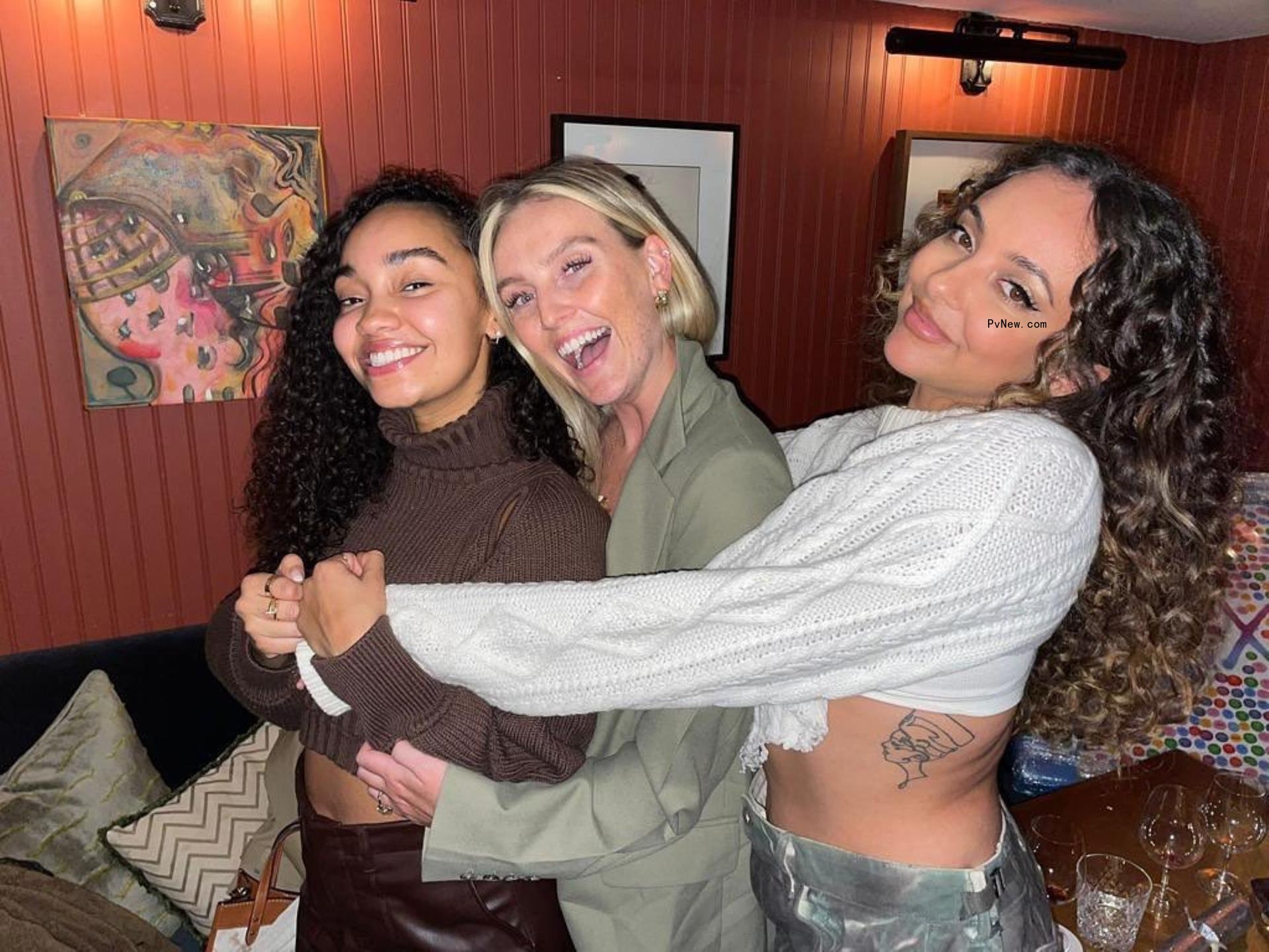 Leigh-Anne Pinnock, Perrie Edwards and Jade Thirlwall sharing a group hug.