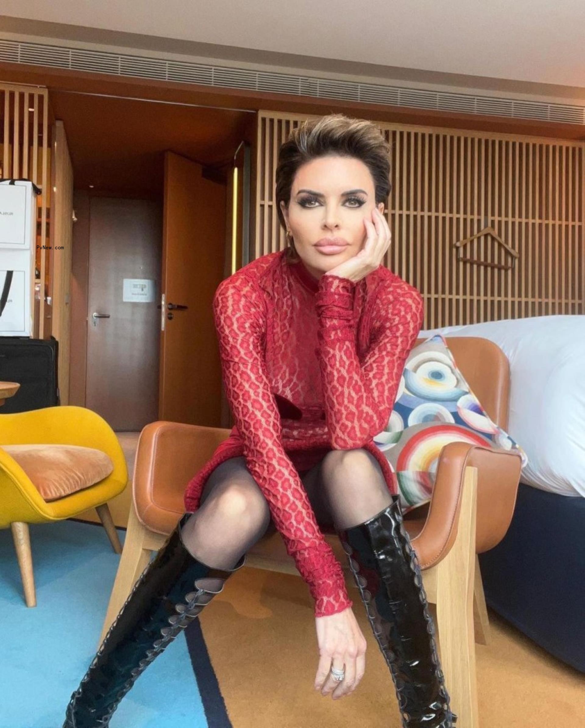 Lisa Rinna in a red dress and black boots.