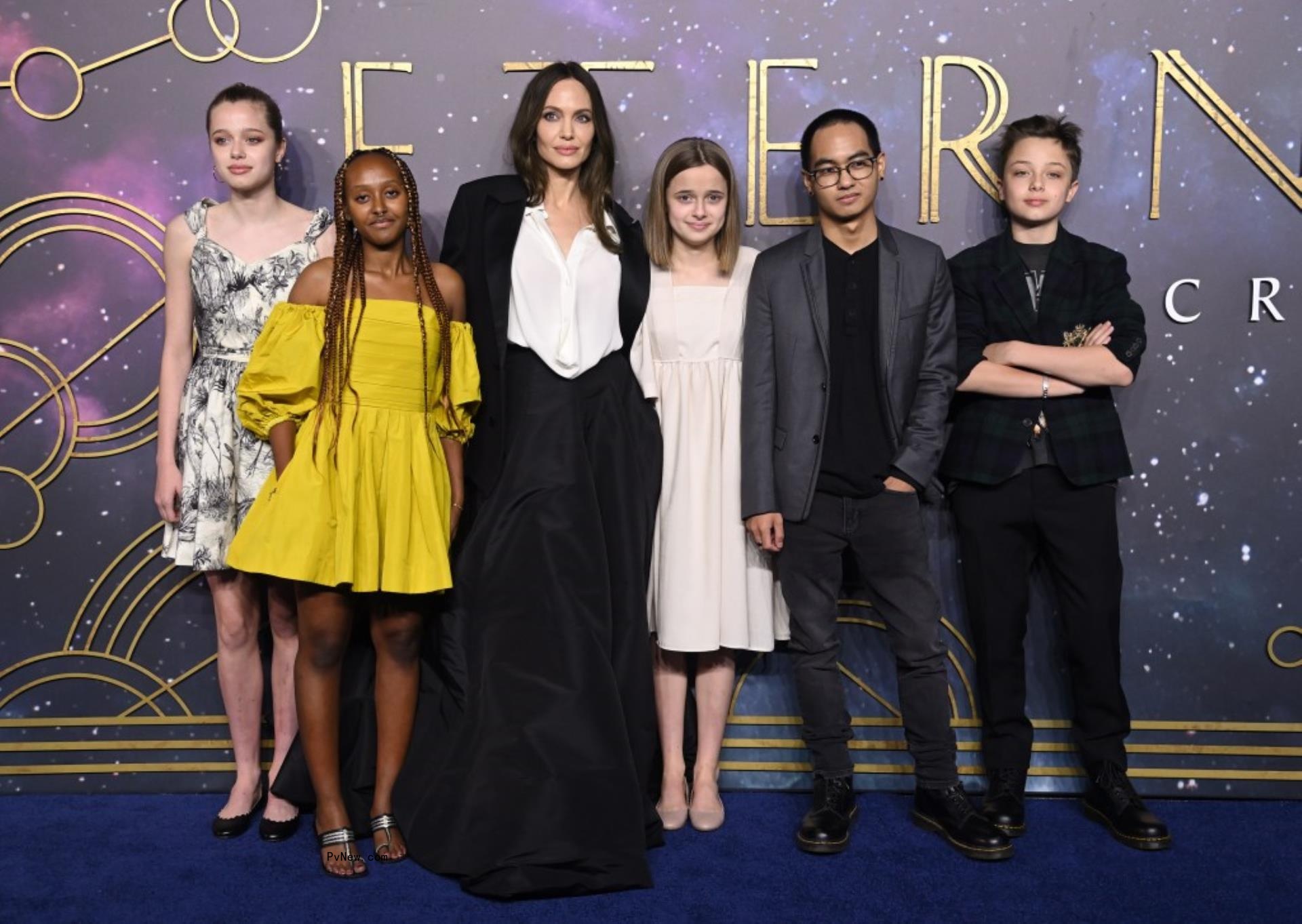 Angelina Jolie with five of her kids on a red carpet.