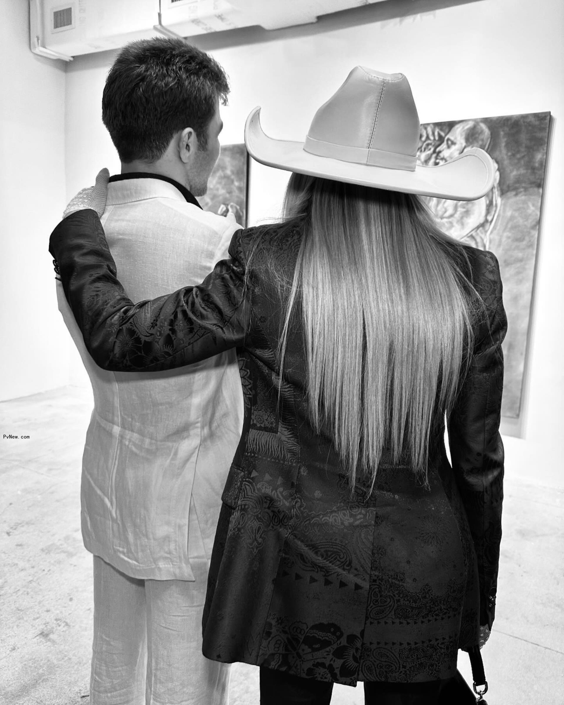 mado<i></i>nna with her arm wrapped around rocco ritchie looking at one of his paintings