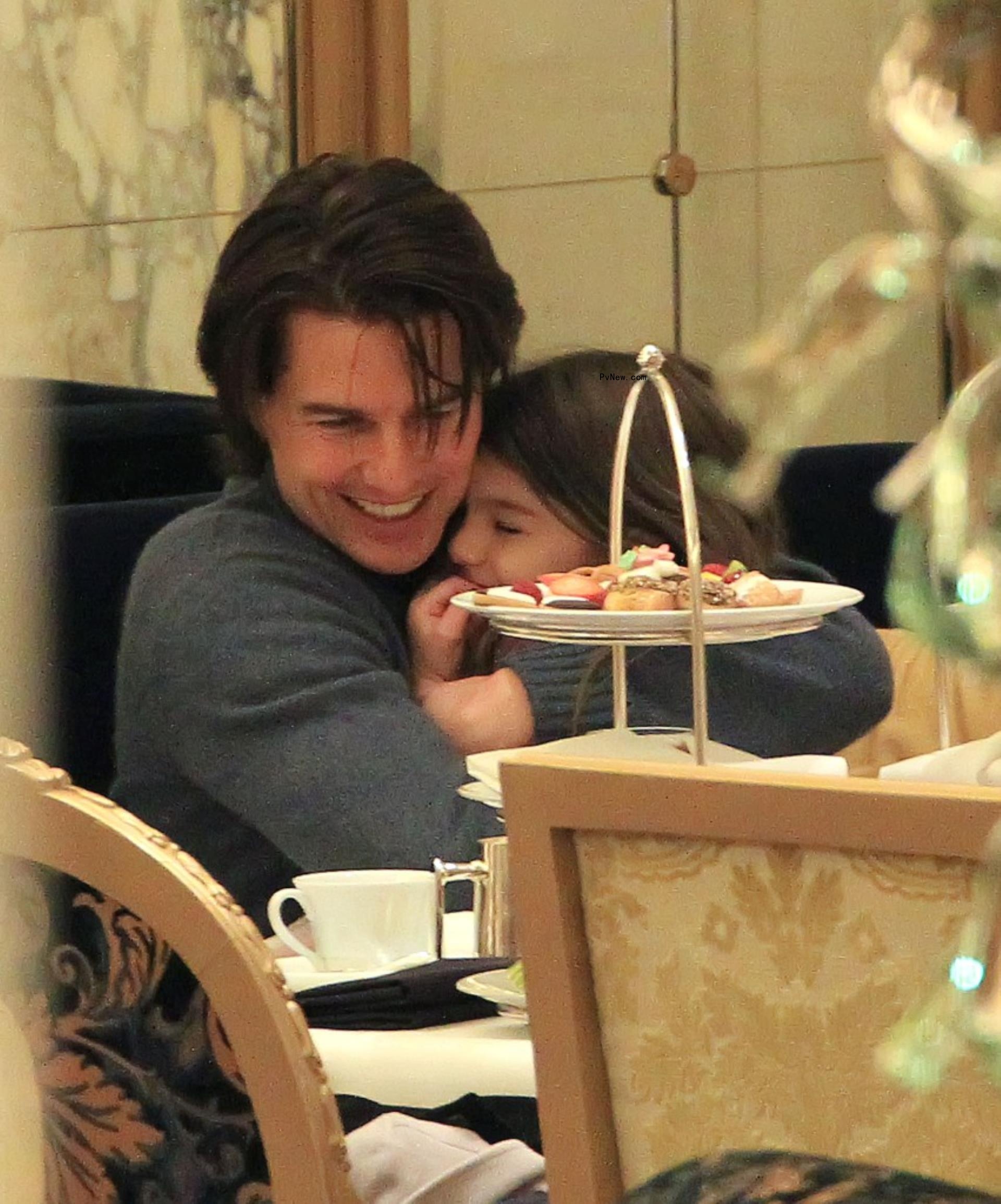 Tom Cruise cuddles daughter Suri Cruise.