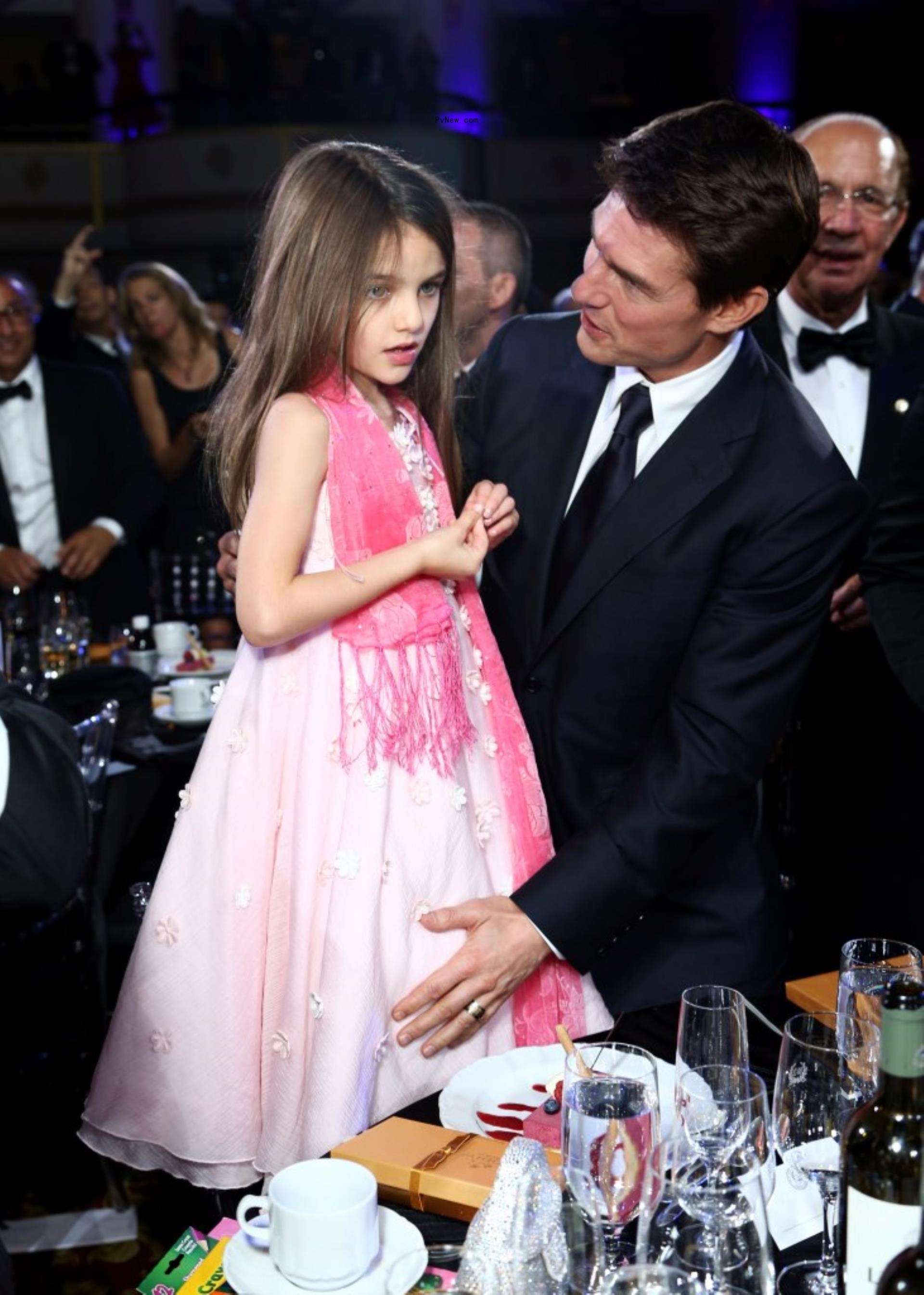 Tom Cruise and Suri Cruise, in a pink dress, at the Friars Club awards.