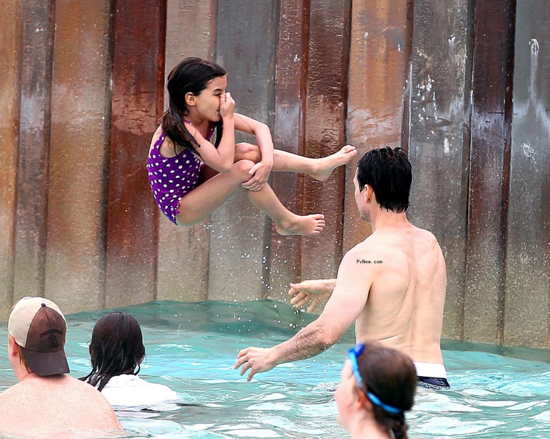 Suri Cruise jumps in the water with her dad Tom Cruise at Disney World.
