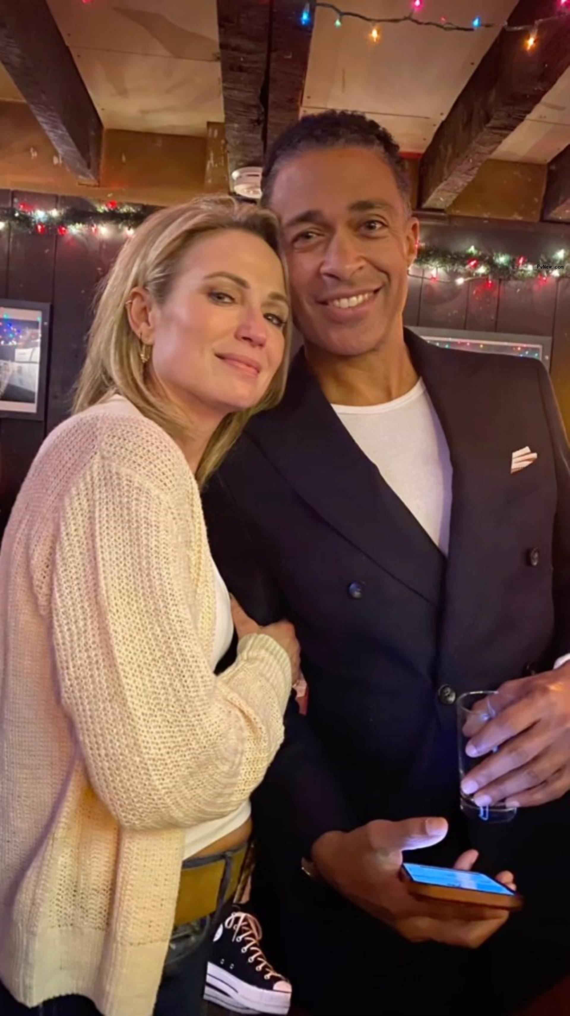 Amy Robah and T.J. Holmes pose together