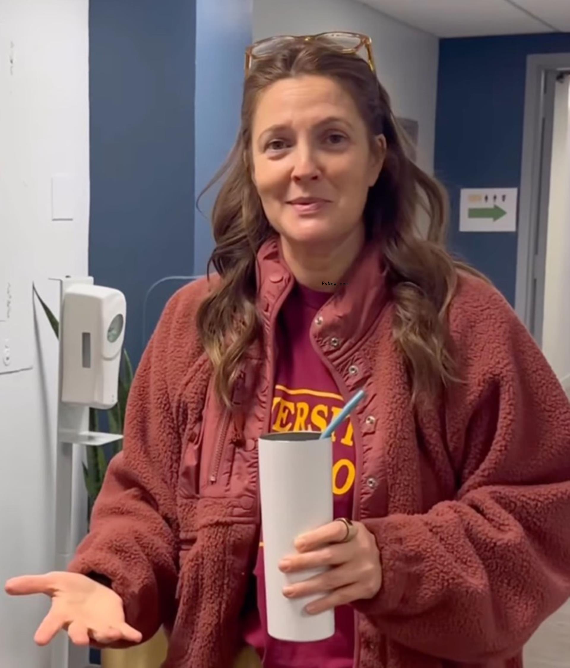 Drew Barrymore holding a cup. 