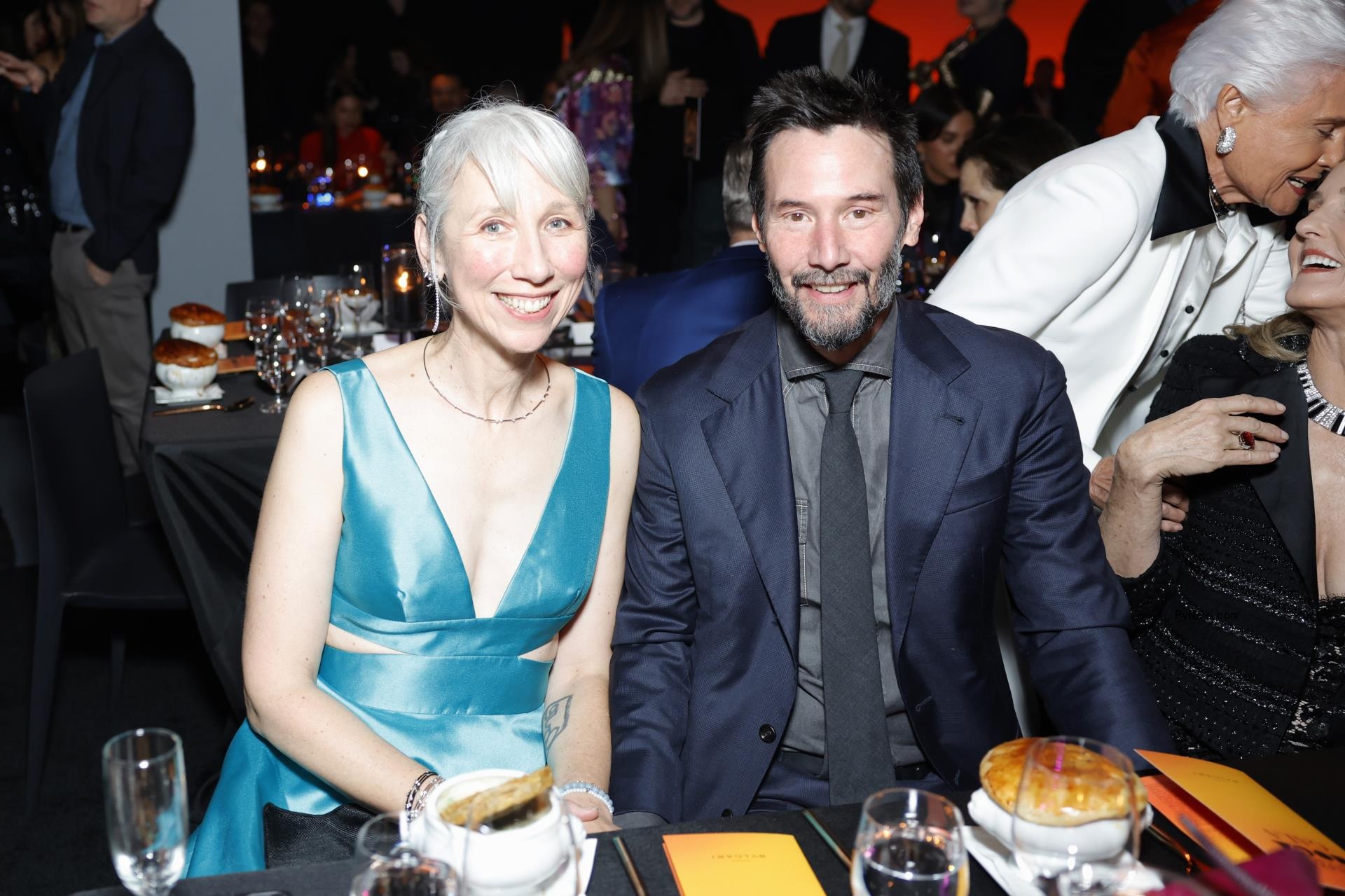 Alexandra Grant and Keanu Reeves sitting together