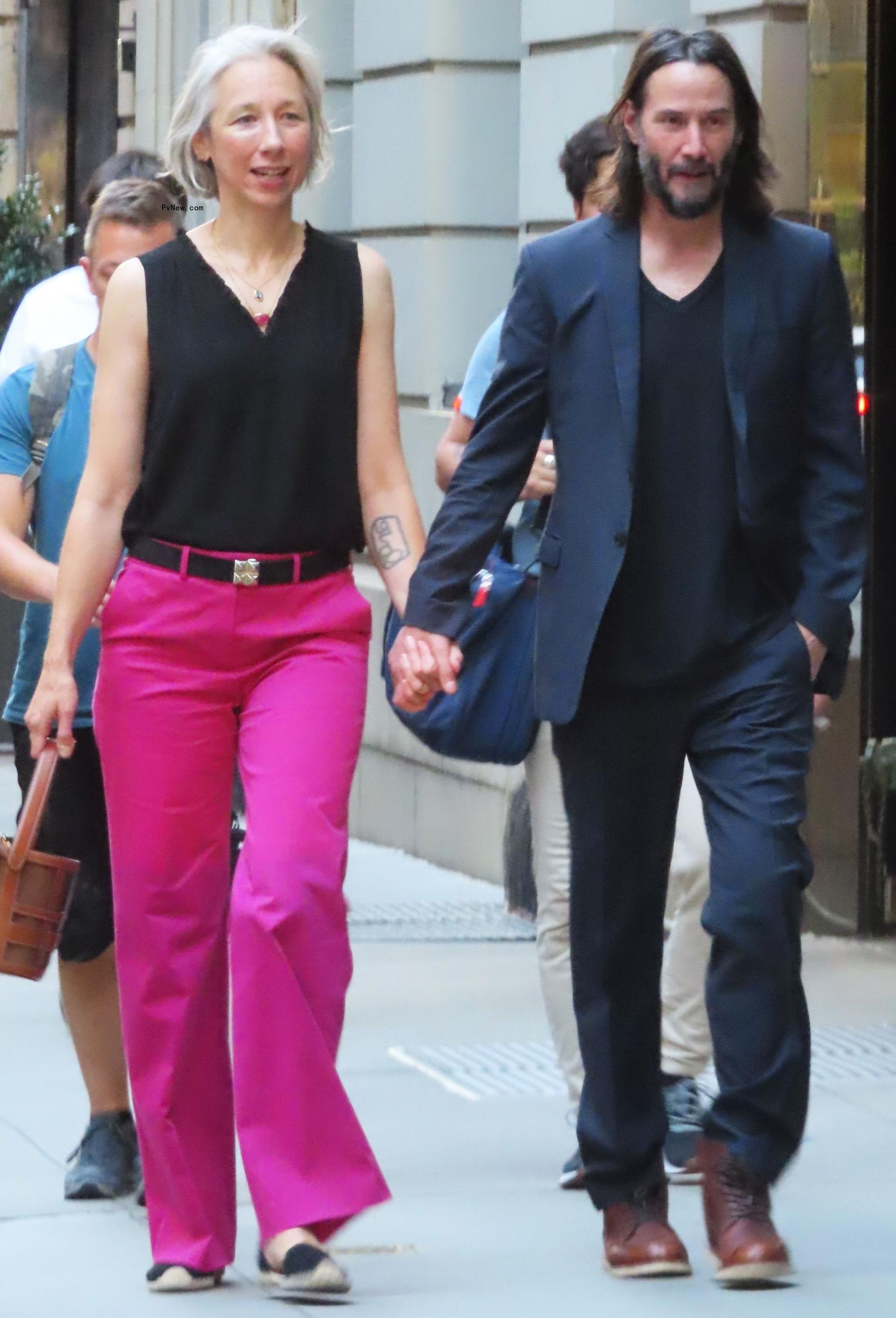 Keanu Reeves and Alexandra Grant walking together
