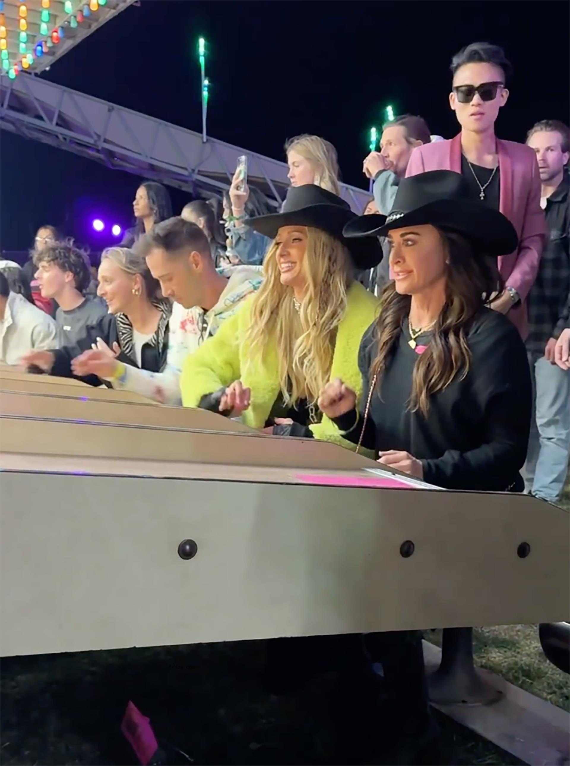 Kyle Richards and Paris Hilton playing skeeball at Coachella