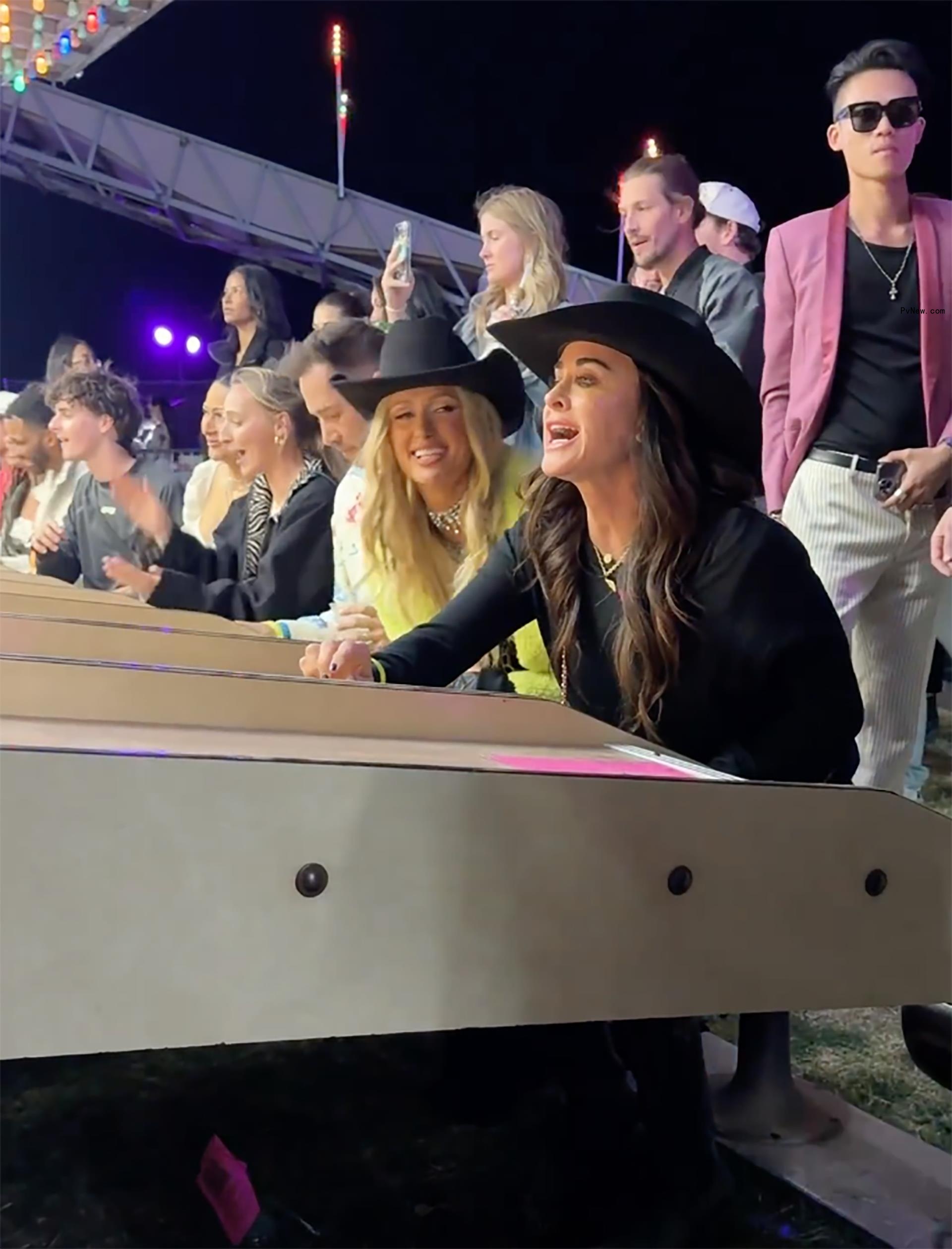 Kyle Richards and Paris Hilton playing skeeball at Coachella