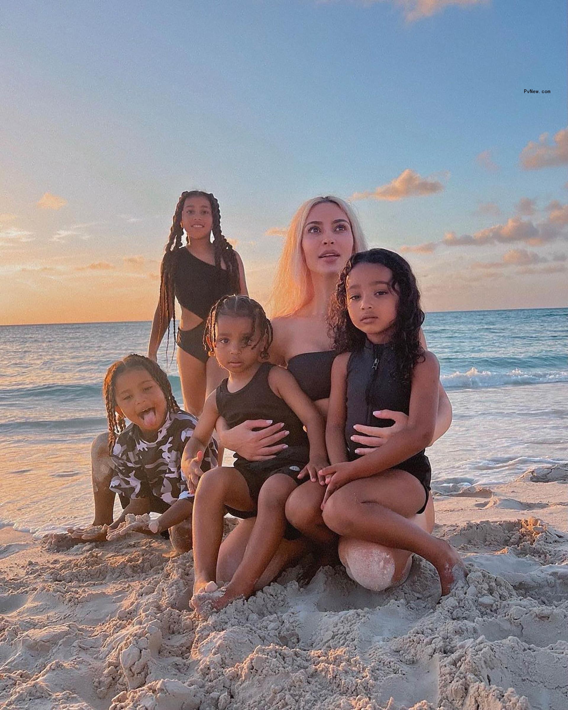 Kim Kardashian with her kids on a beach.