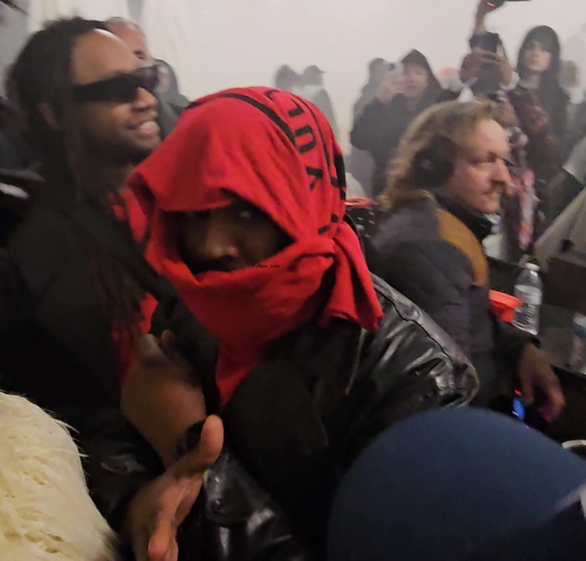 Kanye West with a red scarf at a party in Las Vegas.