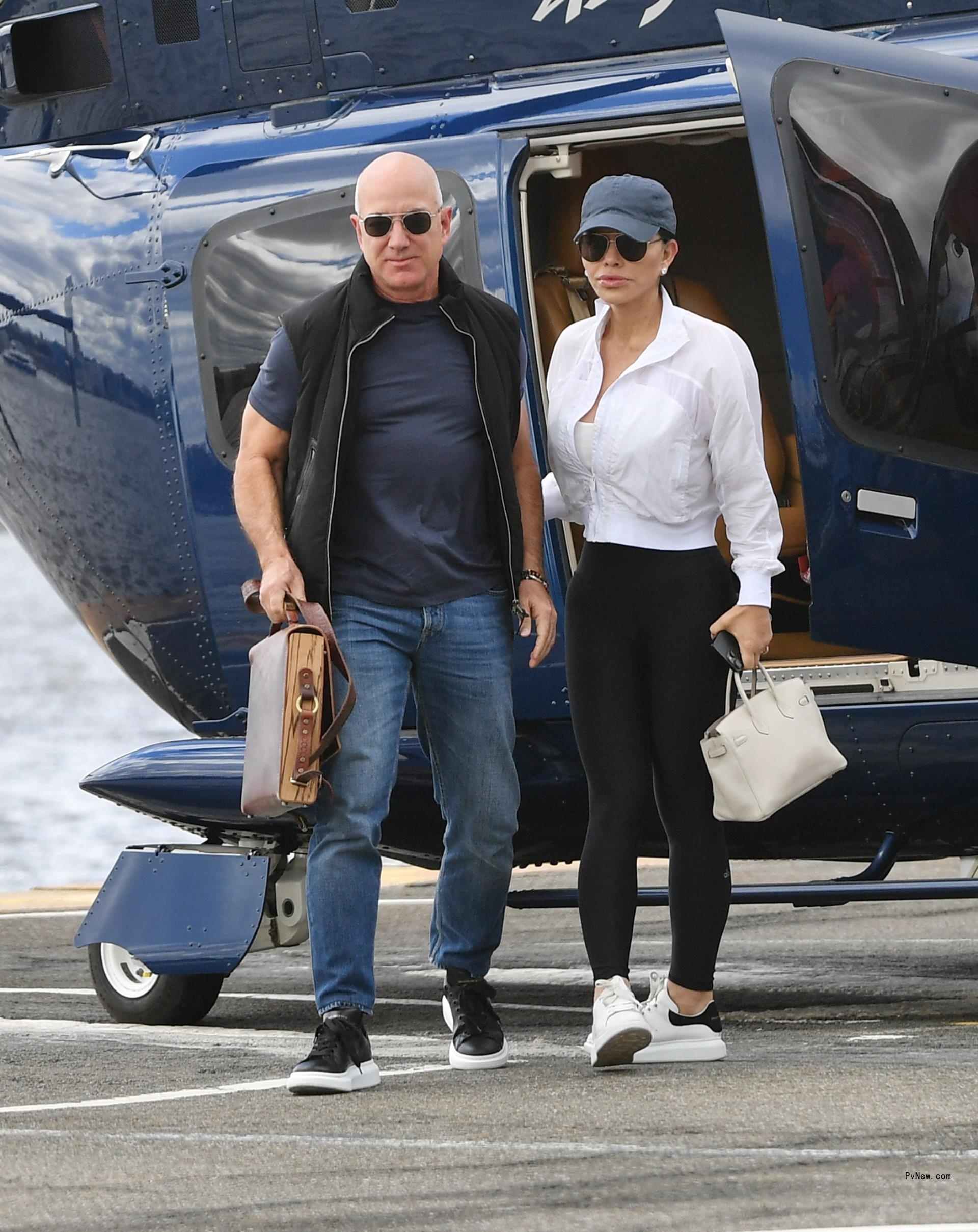 jeff bezos and lauren sanchez exiting a helicopter