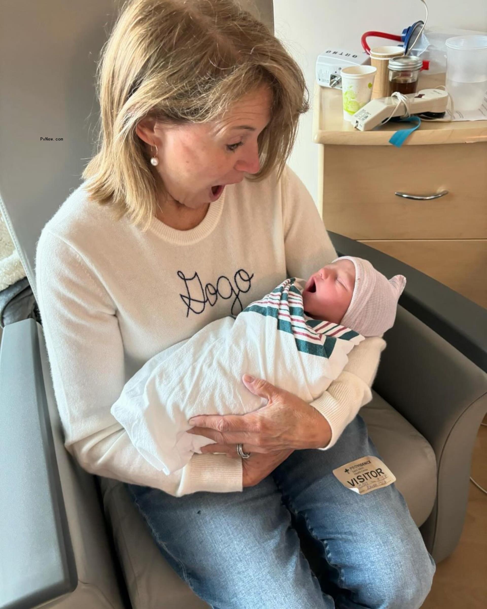 Katie Couric holding her grandson.