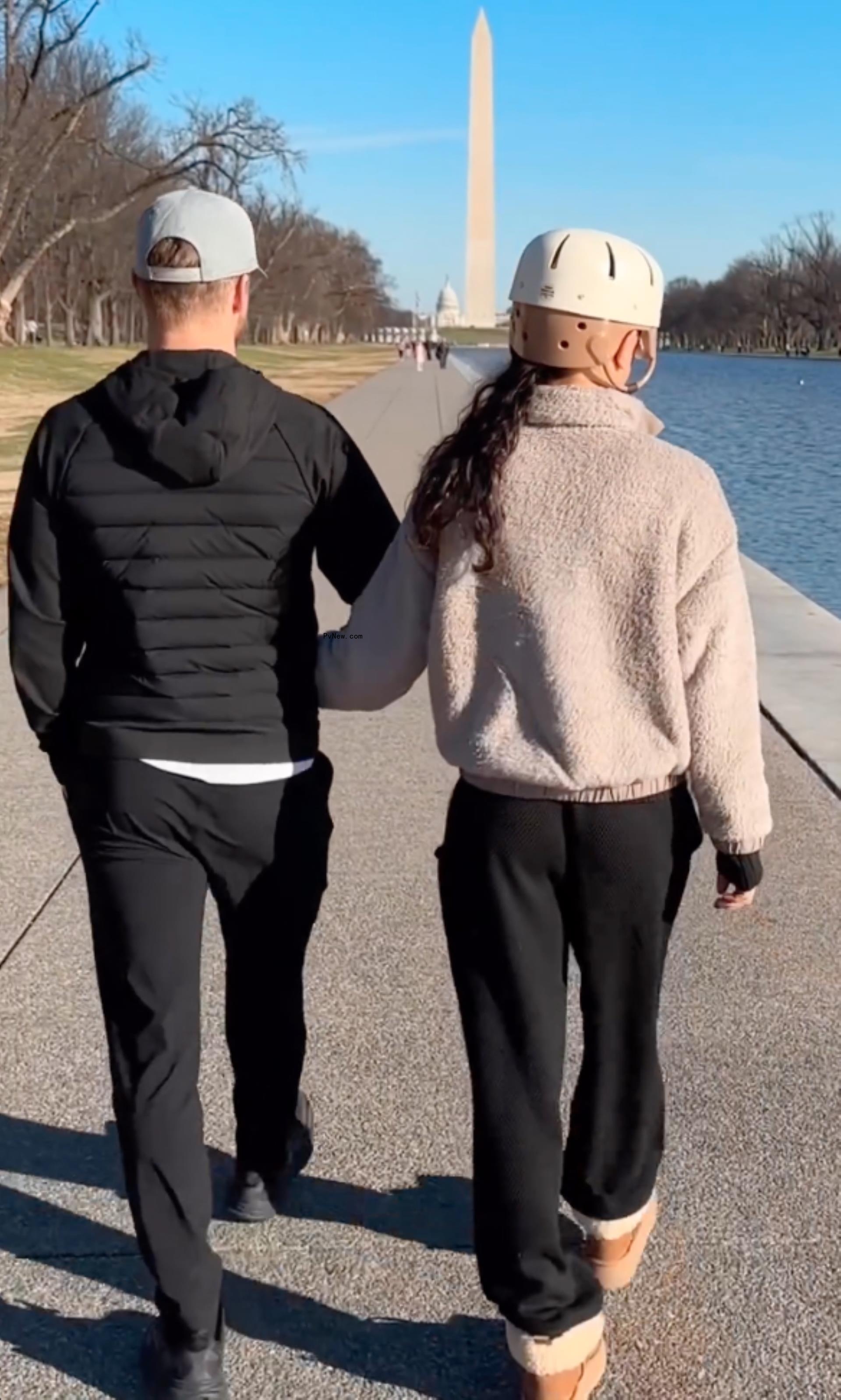 Derek Hough and Hayley Erbert walking near the Washington Monument.