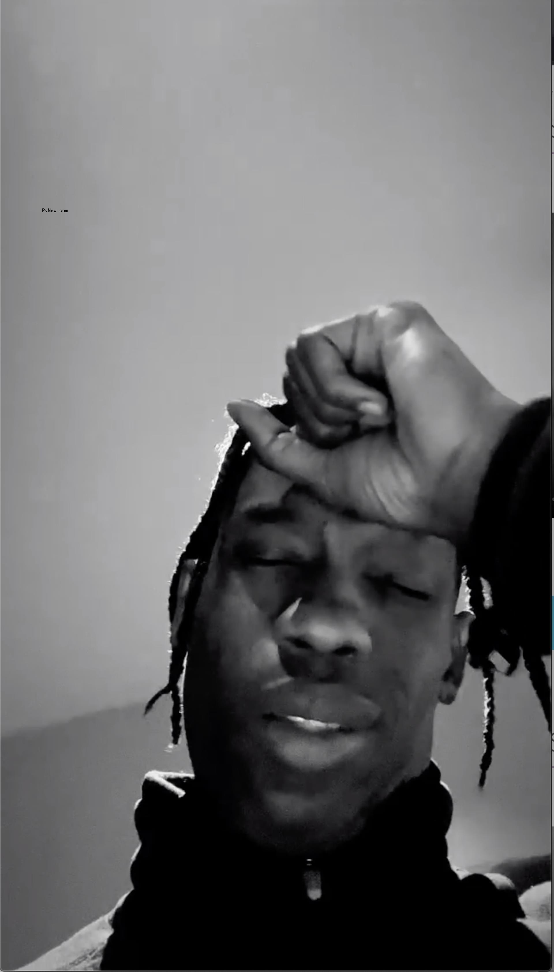 Travis Scott appearing upset in a black-and-white photo.