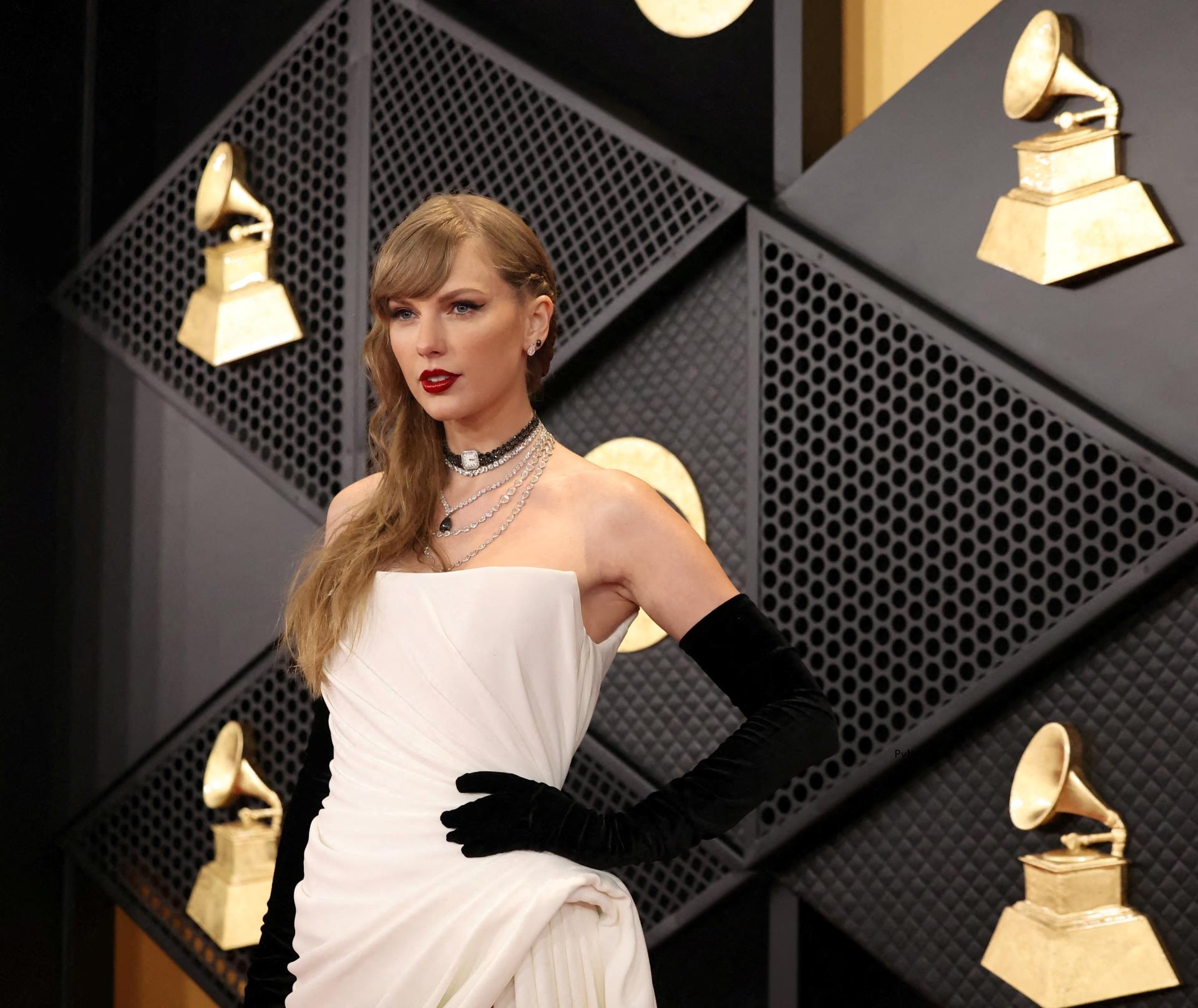 Taylor Swift in a white dress at the 2024 Grammys.
