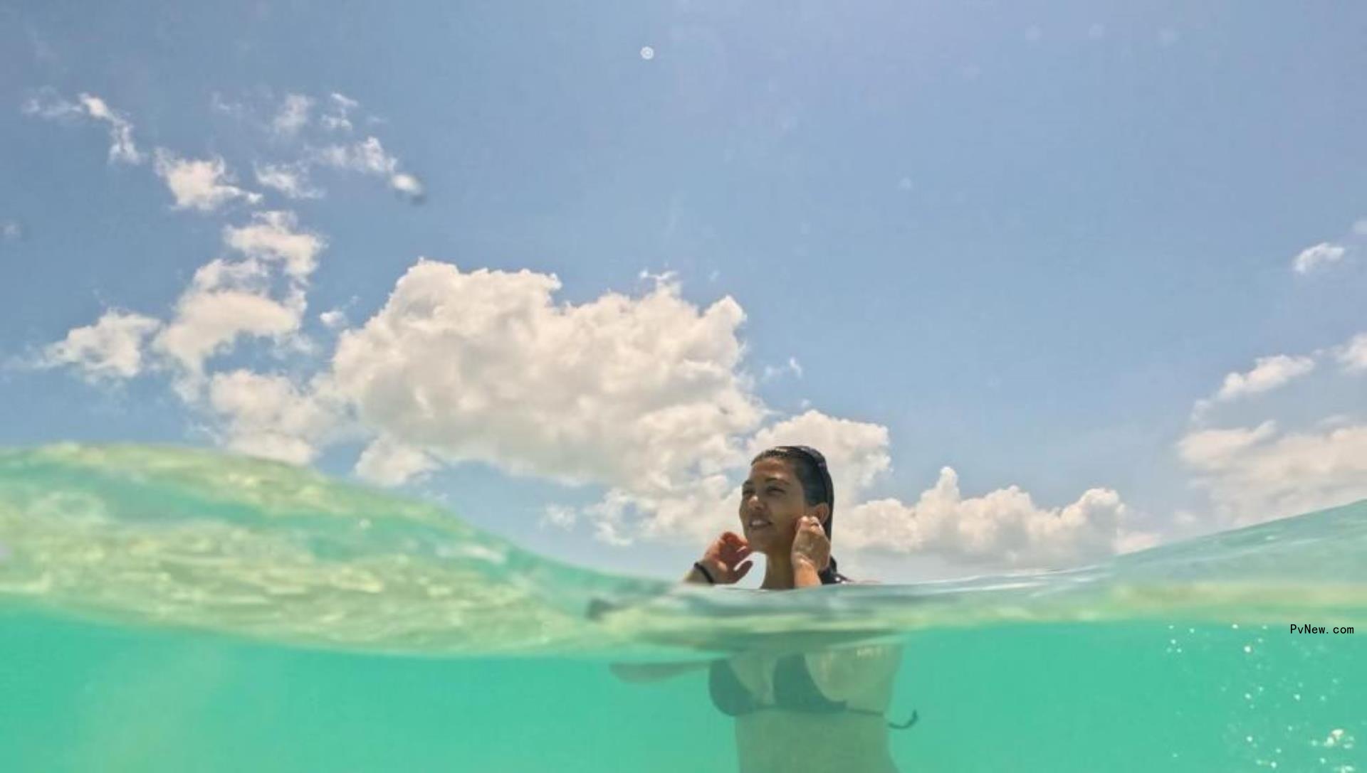 Kourtney Kardashian in a bikini swimming