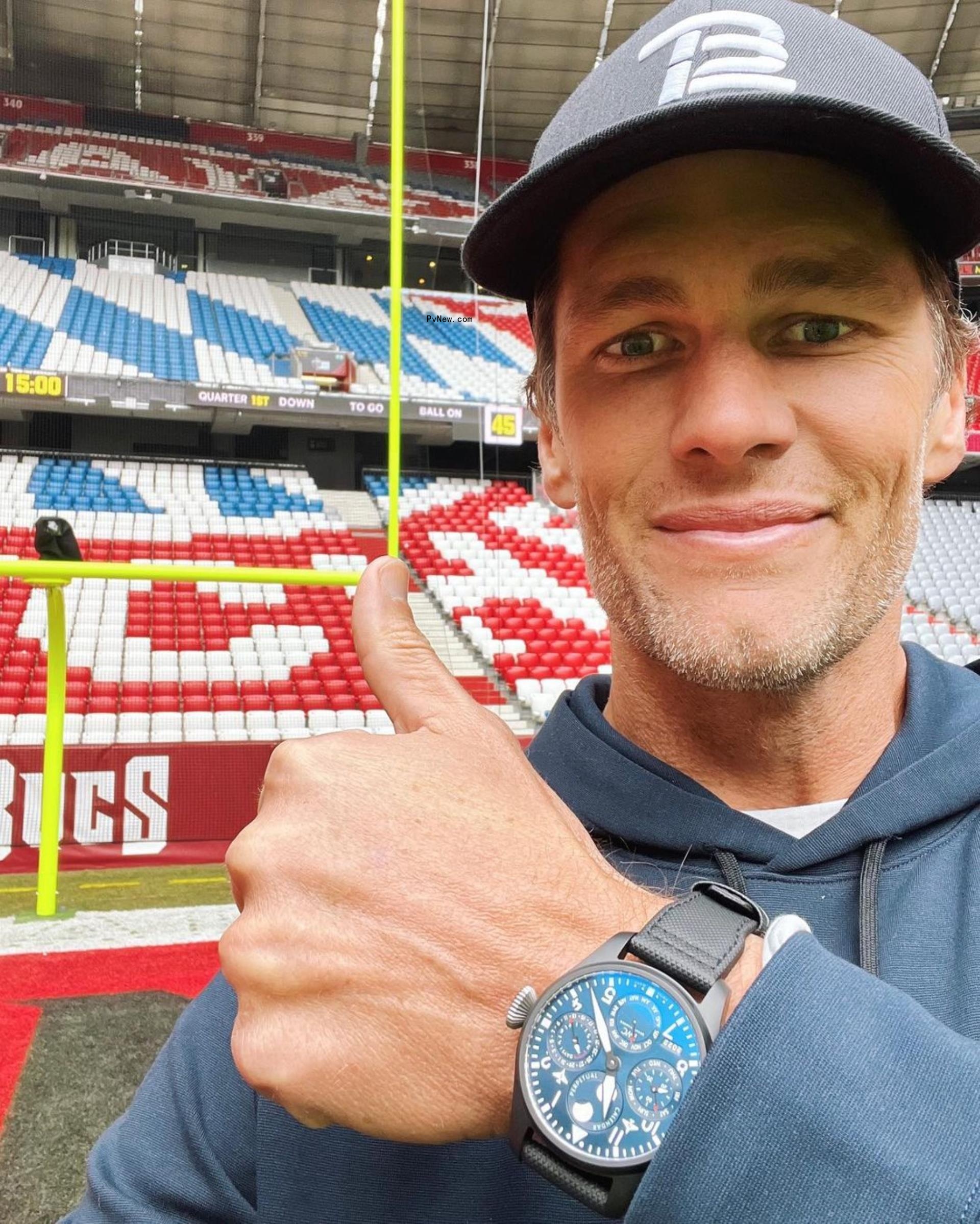 tom brady leaning against a wall